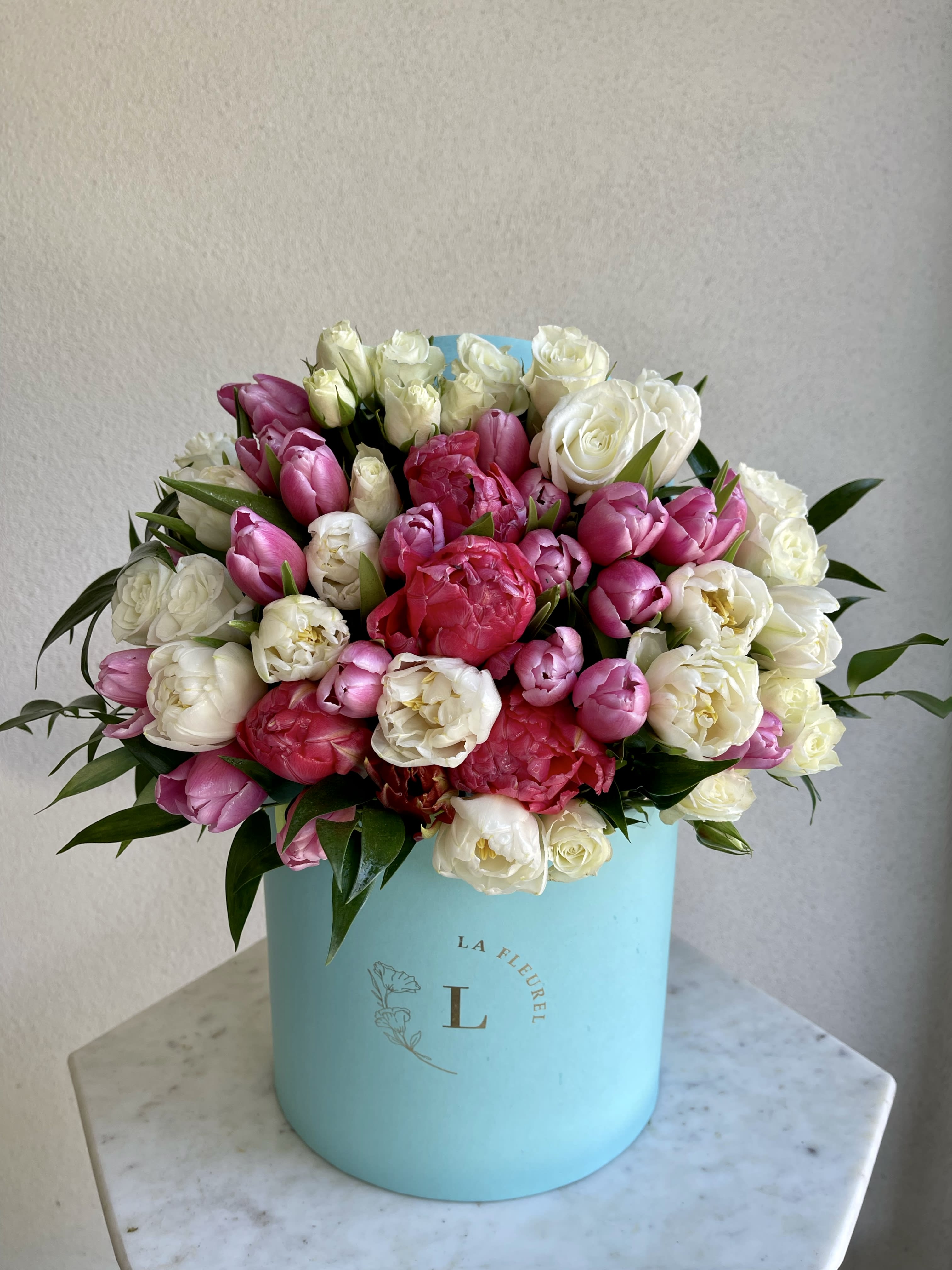 Spring Bloom - This beautiful box contains a combination of 14 to 17 fresh tulips and spray roses in a Tiffany box. This floral arrangment is the perfect gift for your loved one!  Arrangement includes: Fresh spray roses and tulips SMALL BOX  Custom greeting card