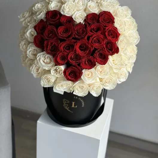 Lovely Heart Arrangement - This beautiful box contains a combination of 65-75 fresh roses in an ivory box. This floral arrangment is the perfect gift for your loved one!  Arrangement includes: Fresh red and white roses Custom greeting card