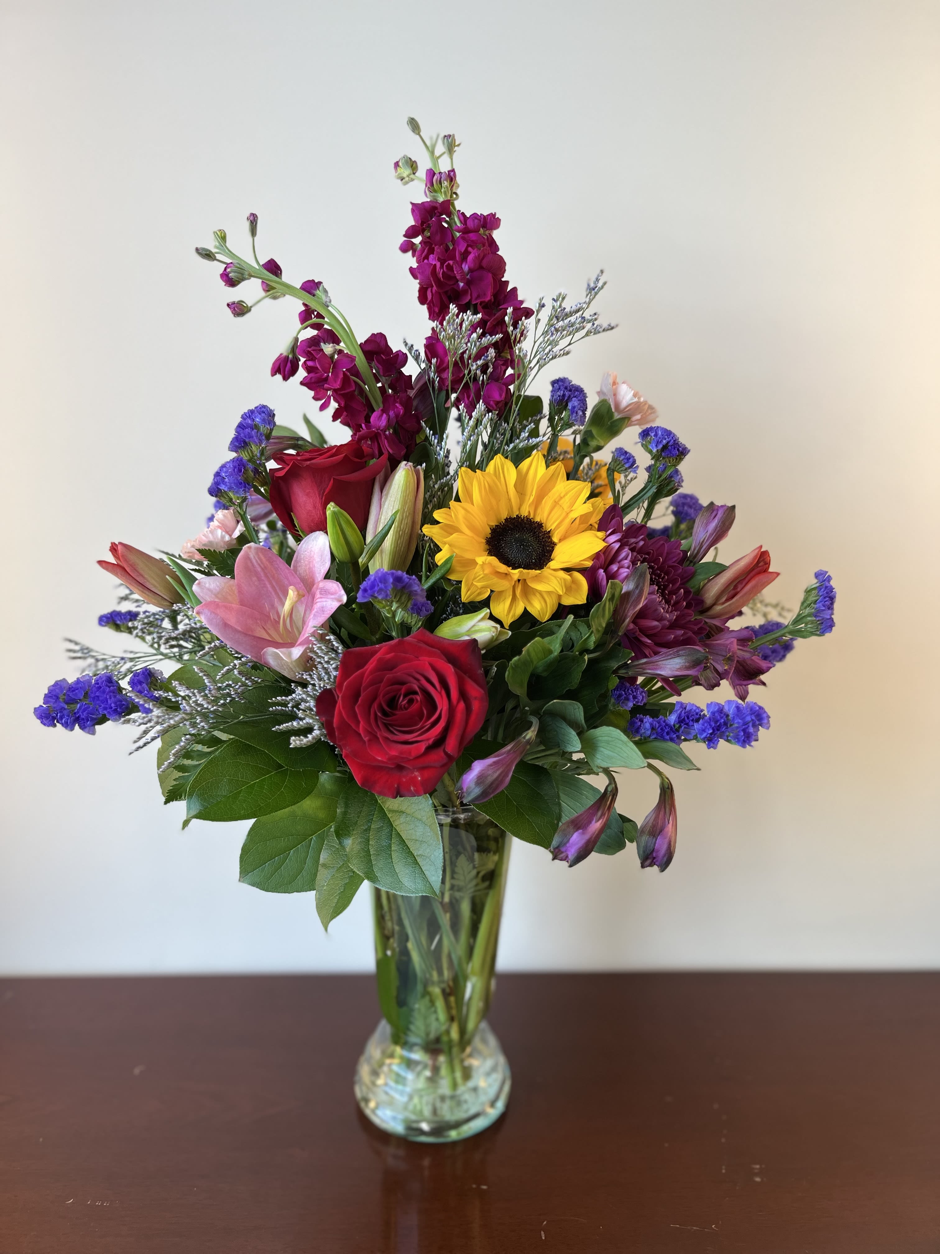 True Love True Love - This gorgeous mix of seasonal blooms is sure to bring a smile. Impressively presented in an urn shaped vase for maximum impact-