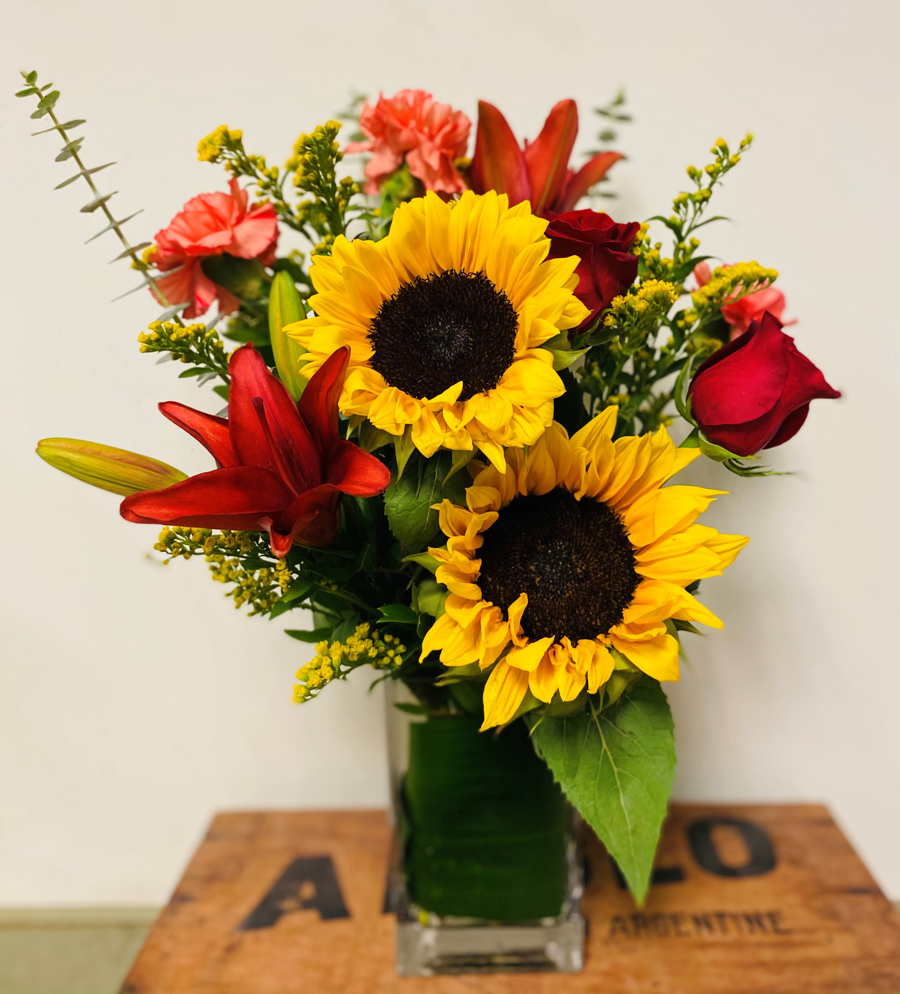 Vibrant Views Bouquet - The Vibrant Views Bouquet brings cheer with each sunlit bloom. Gorgeous sunflowers bring their beauty to this arrangement along with orange roses,  Asiatic lilies, carnations, and solidago for a sophisticated and modern look.  