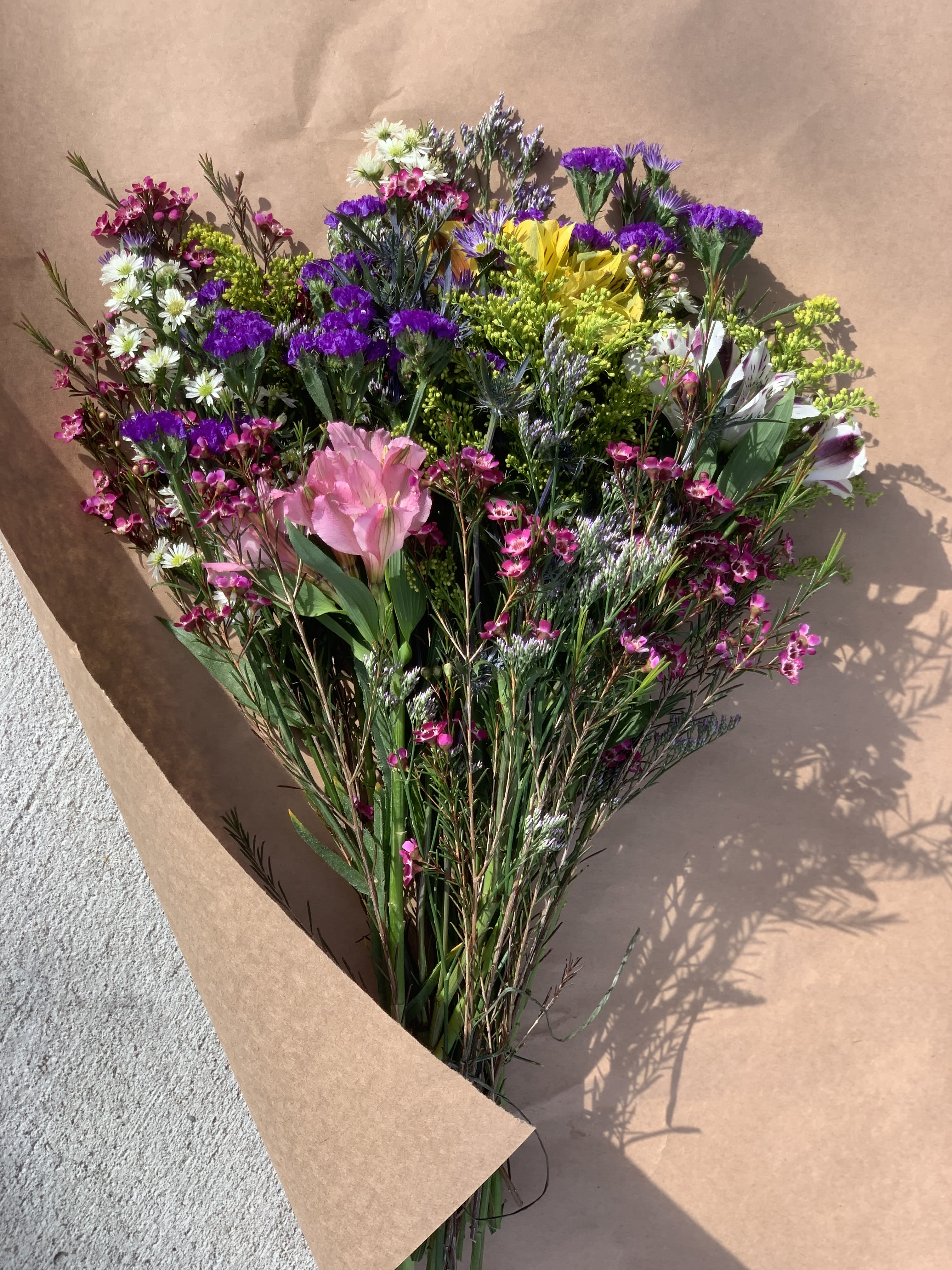 Wild Flower Creation! Wild Flower Creation! - We created the perfect wrapped wild flower bouquet with a mix of asters, fillers and fresh blooms! (No vase- local only)
