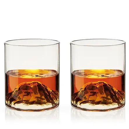 Pacific Northwest Mountain Themed Crystal Tumblers -Set of 2 - Swirl your liquor around the craggy mountain nestled at the base of these unique glasses. These crystal tumblers pay homage to the lofty peaks of the Pacific Northwest with hand-blown, dimensional mountains that rise up in your glass. This handmade item may exhibit slight variations.   Quantity: 2 glasses  Materials: Lead-free crystal Capacity: 9 oz.  Details: Hand blown, Designed in Seattle Care: Dishwasher safe  Viski, a name that epitomizes sophistication and expert craftsmanship, presents an enchanting selection of high-end glassware, barware, and wine accessories that serve as perfect selections for the autumn season. As you plan a backyard bonfire with friends, host a dinner party on Labor Day with family or choose the perfect fall wedding present, let Viski’s offerings enrich the celebration of these crisp, cool days. Our products not only raise the bar of mixology but also add a touch of luxury to any home bar, making every fall occasion memorable