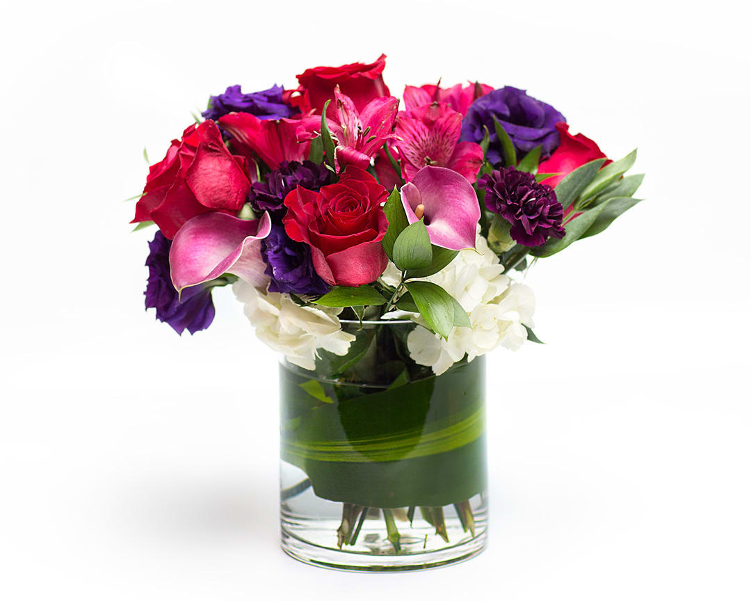 Eternal Love - A rich display of our favorite calla lilies, roses with purple accents designed in a romantic  nosegay style. Delivered by a real Portland florist.