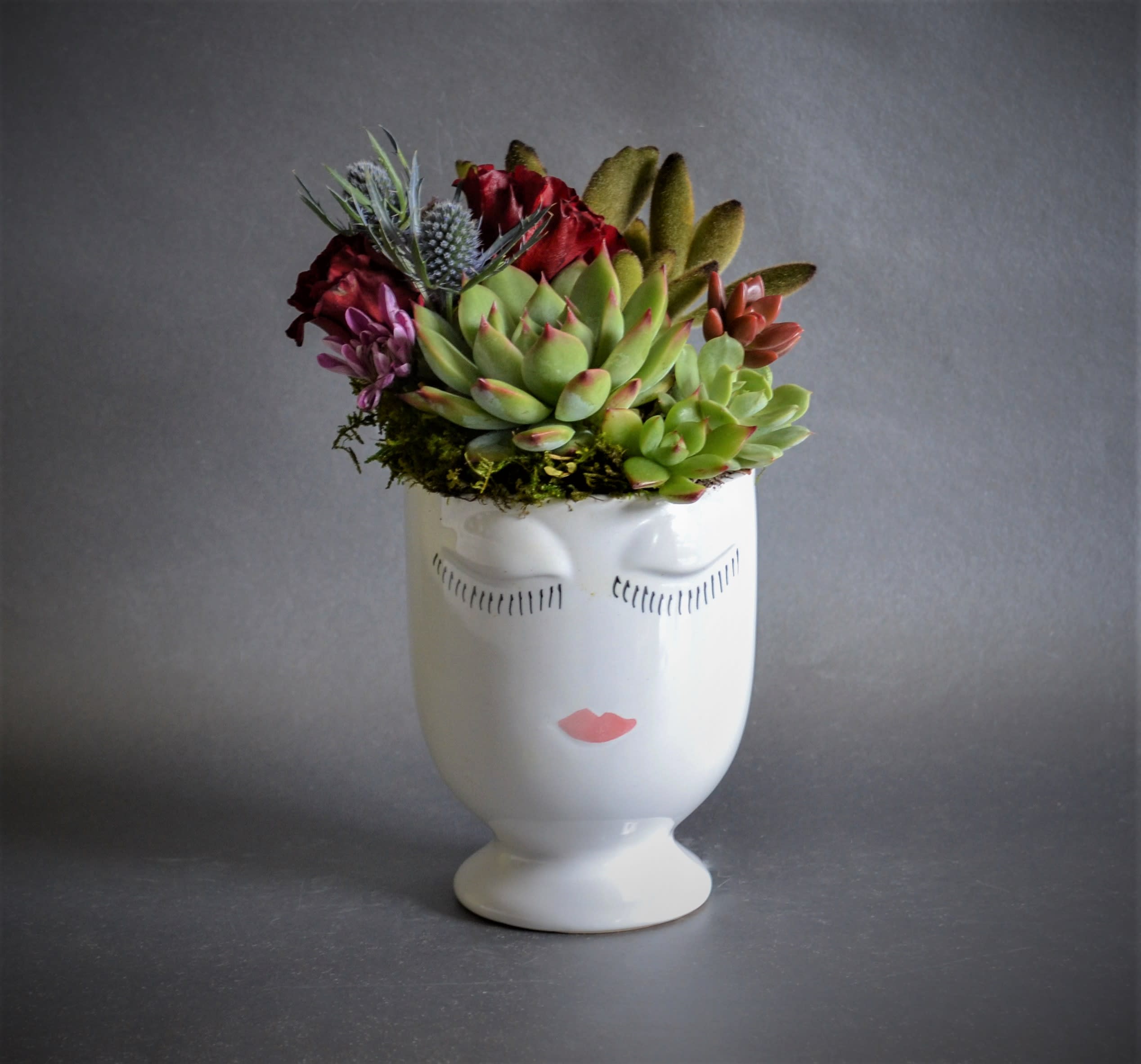 Brea Brea - A Celfie Vase filed with succulents. The Container is 5.5 inches in Height and 4 Inches wide Arrangement is approximately 8 Inches high and 6.5 wide. Contains 4 succulents on standard, 6 succulents on deluxe. Exact succulents are not always available.