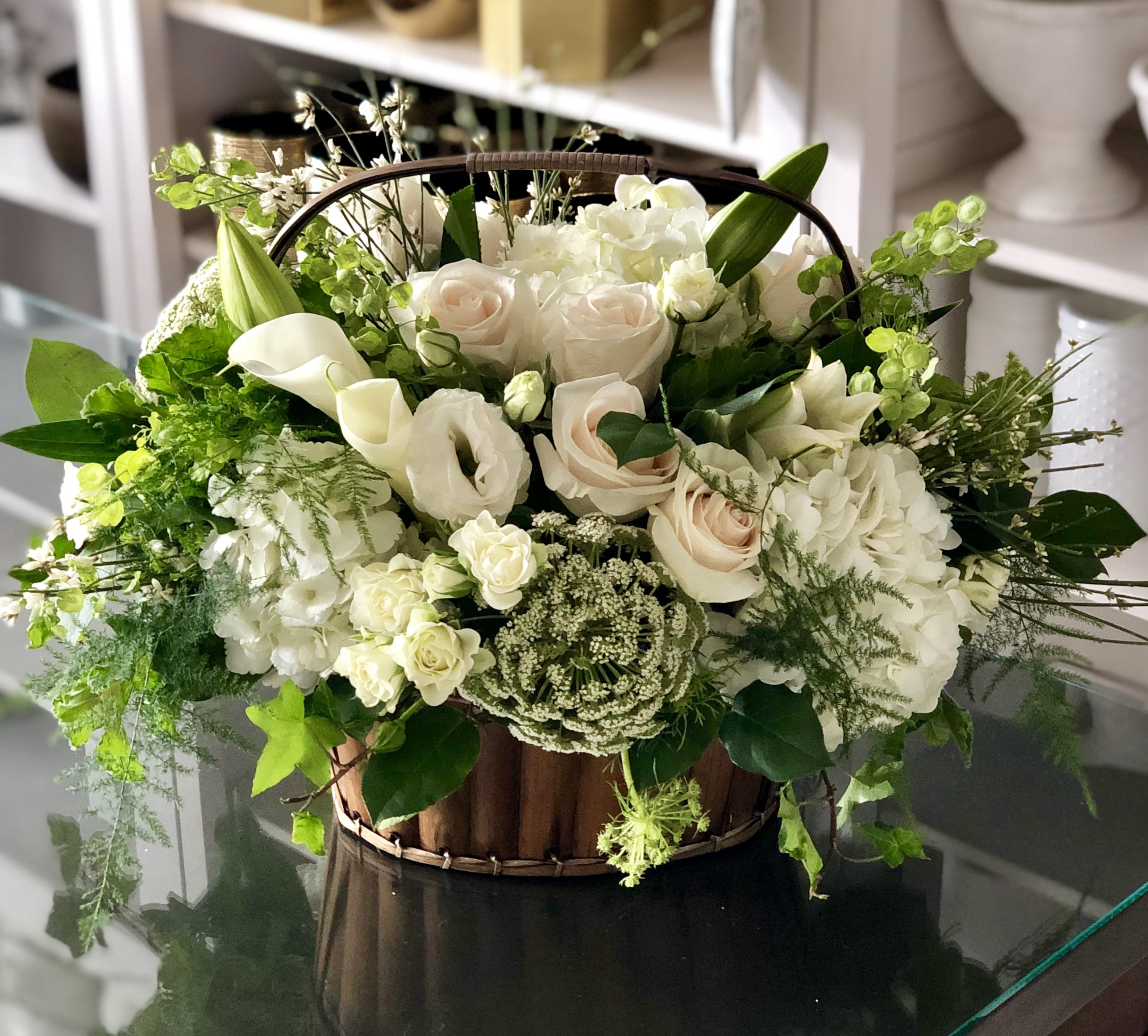 Memorable Moments Memorable Moments - Crafted with great care and consideration, this elegant basket is filled with an assortment of delicate white florals that lend an air of tranquility and solace to any space it graces. The choice of white blooms is deliberate, symbolizing purity, innocence, and the hope of a new beginning after even the darkest of times.