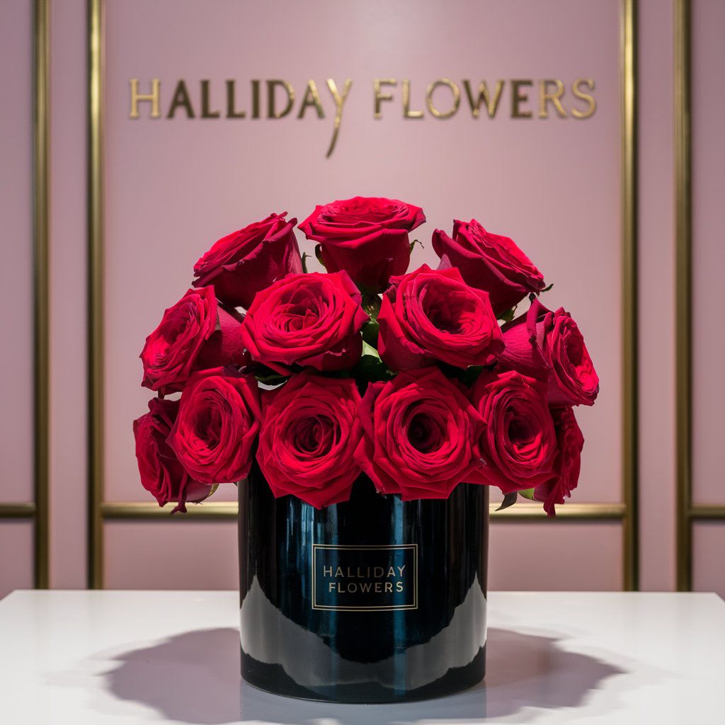 Simply red  - This is a circle vase wrapped with a tea leaf and filled with red roses.