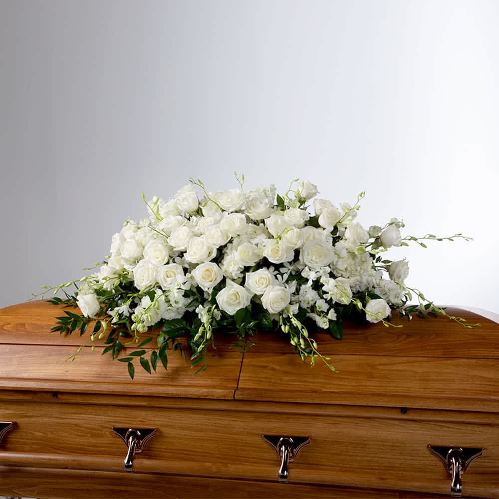 Tranquility by BloomNation™ Tranquility by BloomNation™ - An all white tribute, this full casket spray is pure and tranquil. Featuring a variety of white flowers and greenery, this elegant spray evokes a feeling of peace.