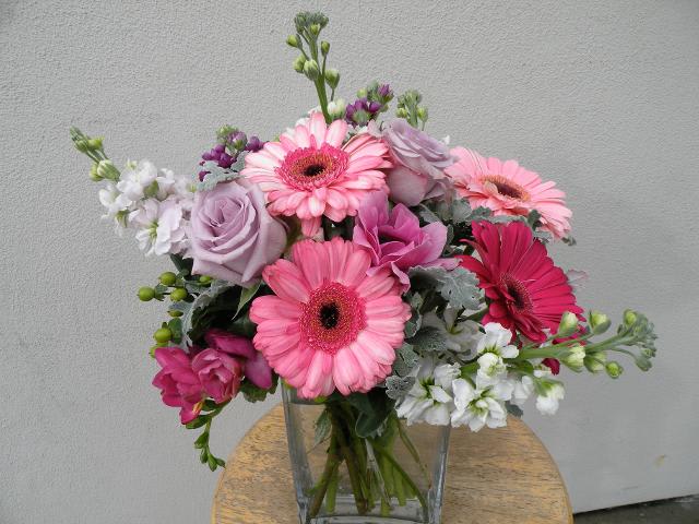 Shades of Pink Shades of Pink - This collection of gerber daisies, lavender roses and sweet stock, will surely warm the heart, and deliver smiles.