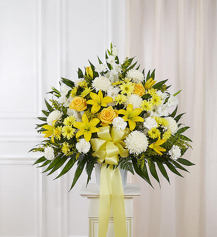 Yellow and White Funeral Basket Yellow and White Funeral Basket - Chrysanthemums, yellow roses, lilies and carnations makeuo this very traditional funeral arrangement.