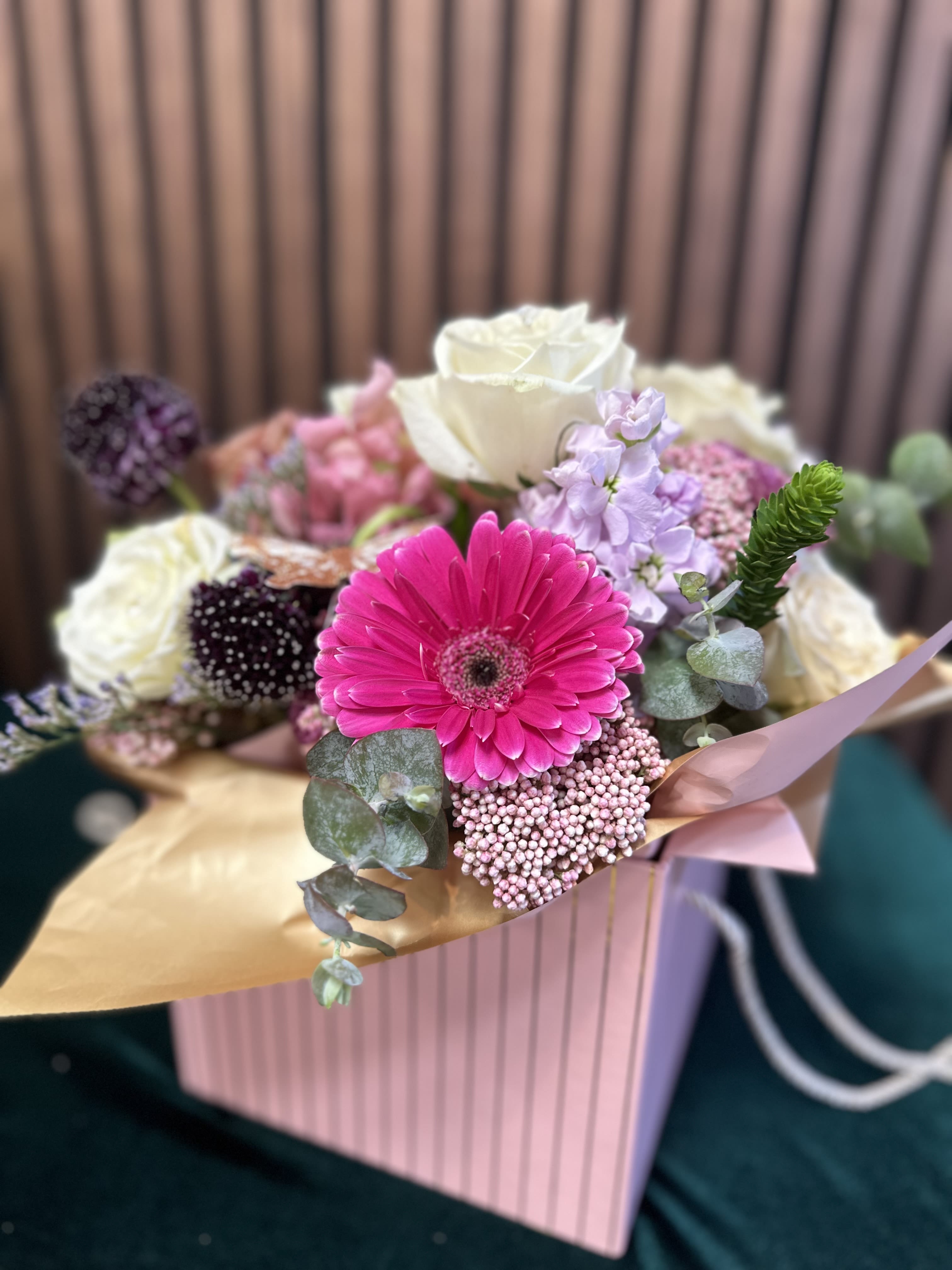 Radiant Dream Bouquet Radiant Dream Bouquet - Brighten someone's day with the Radiant Dream Bouquet! This stunning arrangement features vibrant pink Gerbera, elegant white roses, and striking purple Allium, perfectly paired to create a mesmerizing display of color and beauty. Nestled in a sleek, modern vase, these blooms are more than just flowers—they're a statement of joy and serenity. Ideal for any occasion, the Radiant Dream Bouquet is a delightful way to add a touch of elegance and warmth to any space. Substitution Policy – Always Fresh, Always Beautiful! We strive to deliver the freshest flowers and the most exquisite arrangements. Please note that the bouquet image reflects our original design. In the event that specific flowers or containers are unavailable, our skilled local florists will use the freshest available blooms to create a stunning and comparable bouquet that maintains the spirit and beauty of the original design. Your satisfaction is our priority, and we are committed to delivering a beautiful floral experience every time!
