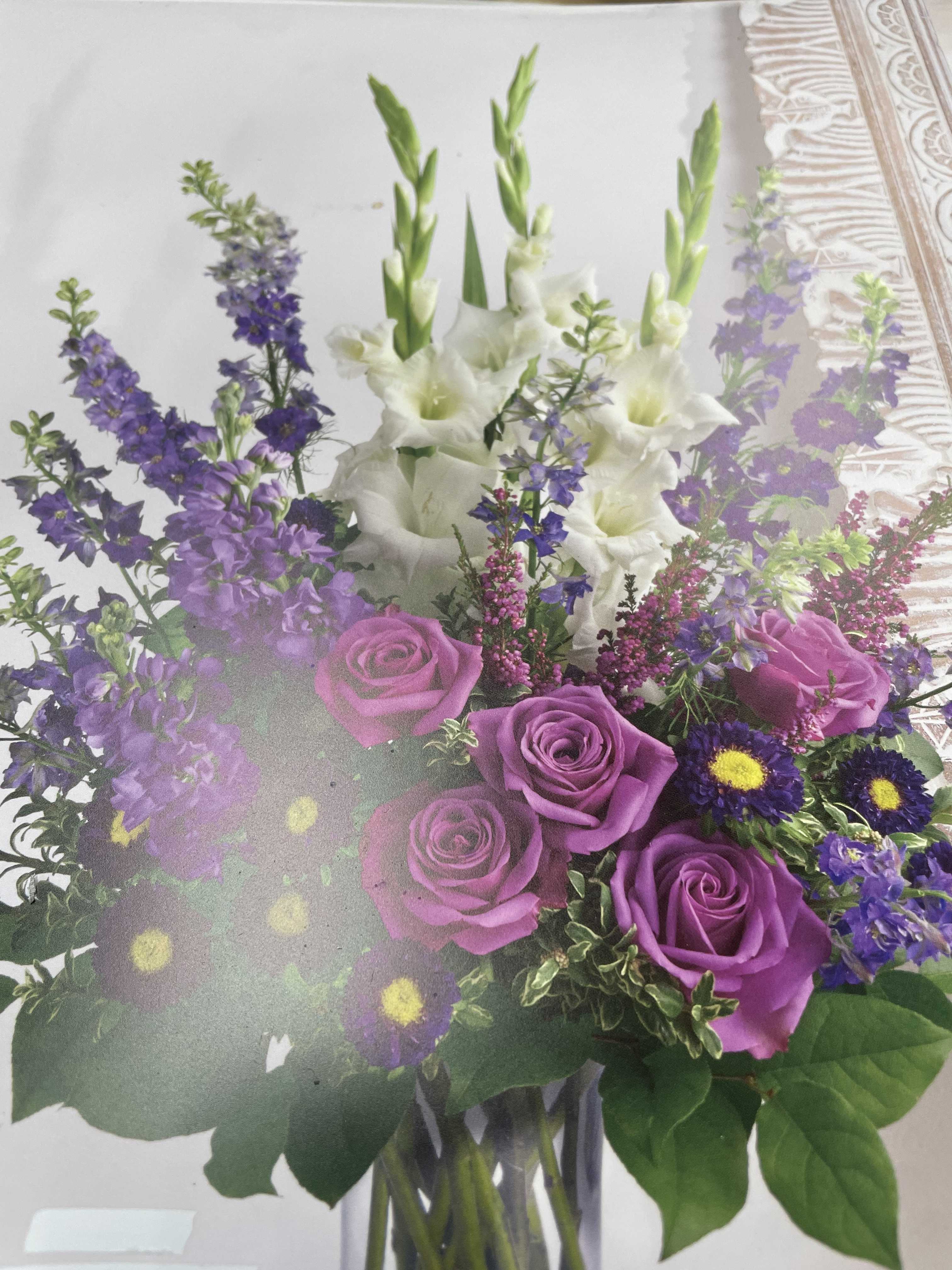 Joyful Remembrance - This bouquet expresses your love for those who had passed and for I Am sorry condolences. The arrangement may contain the following flowers or foliage: Roses, gladiolus, larkspur, lavender, buttons, and others.  Seasonal flowers and foliage will be substituted.  Prices increase with premium and deluxe arrangements.  Please call the store for custom arrangements.  