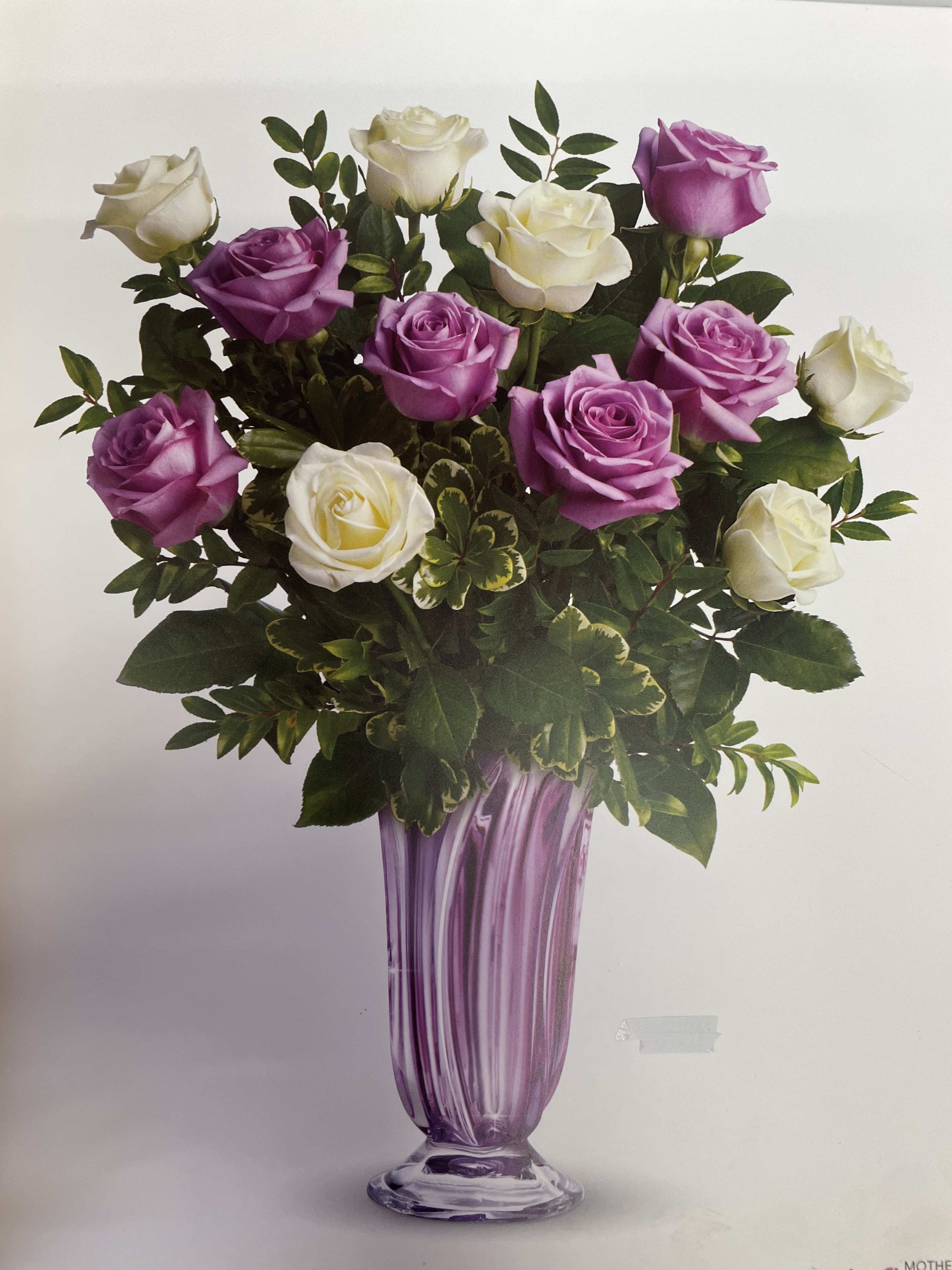 Lavender Beauty - This beautiful bouquet has white and lavender roses with green foliage that would be wonderful for Mother's Day or even Easter.  This can be adjusted as per customer budget.  For all custom made arrangements please call the store.   Seasonal flowers and foliage are subject to substitution.  