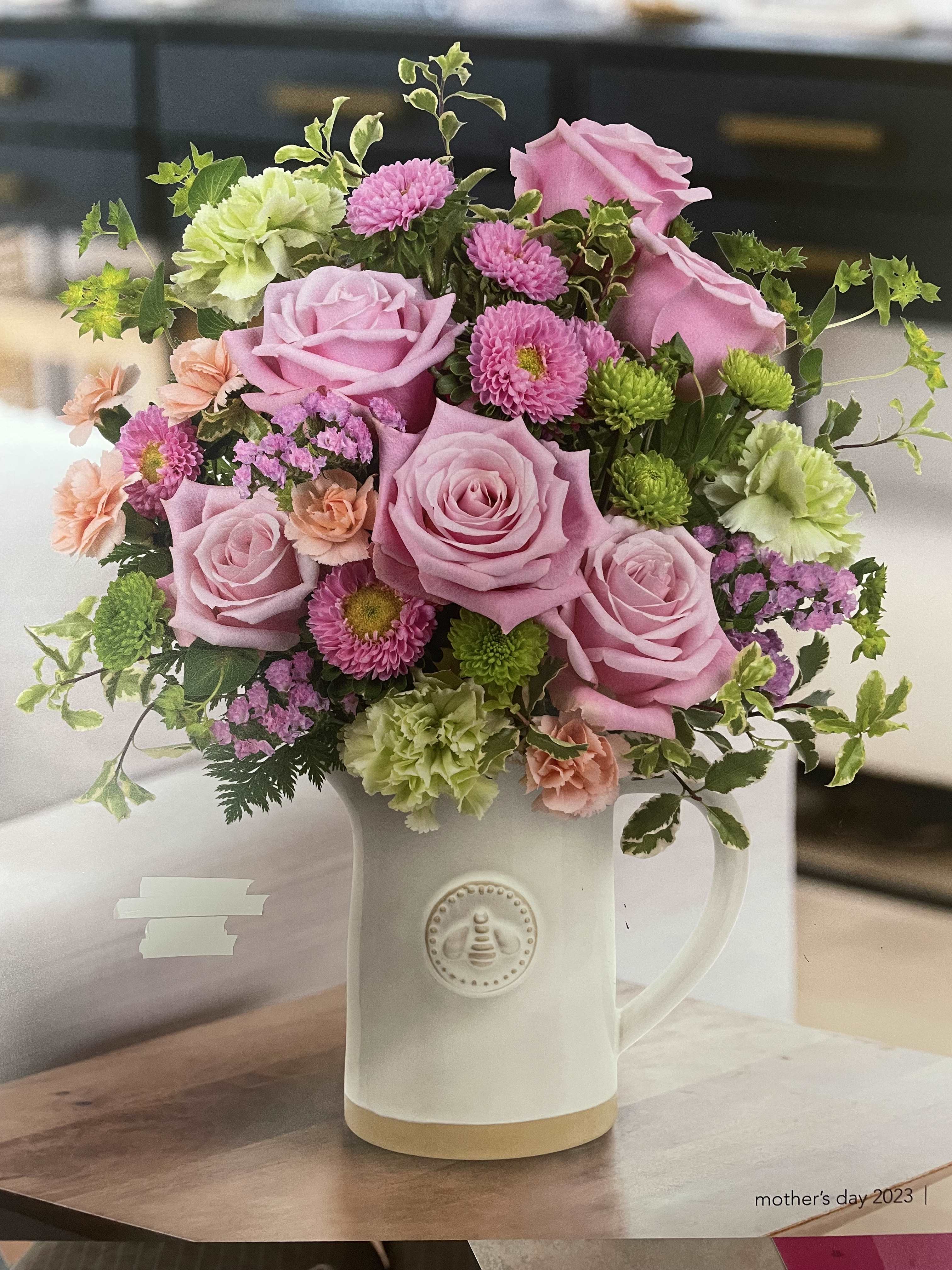 Love you MOM - This beautiful bouquet is priceless and great for Mother's Day.  Contains:  roses, carnations, spider mum, hydrangea, green button, foliage and fillers.  The base container will not be one pictured.   We will attempt to be at close to the picture requested.  Custom bouquet are accepted if you call the store. 