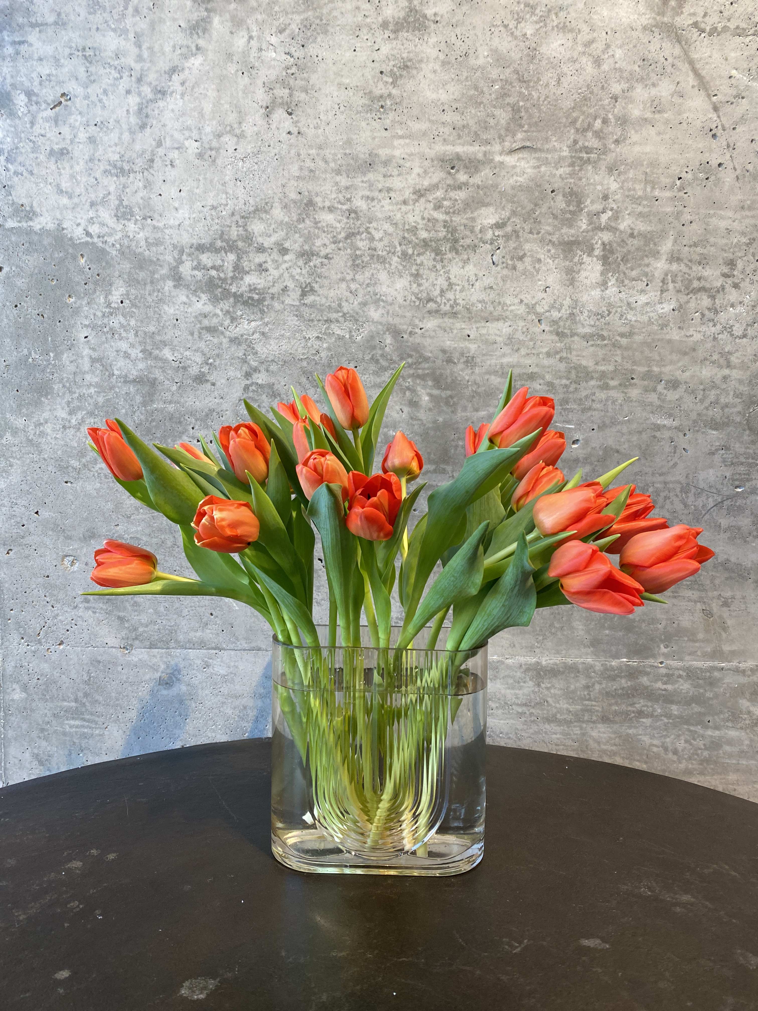 20 Tulips - 20 tulips placed elegantly into an elevated vase. Please specify color when ordering. 