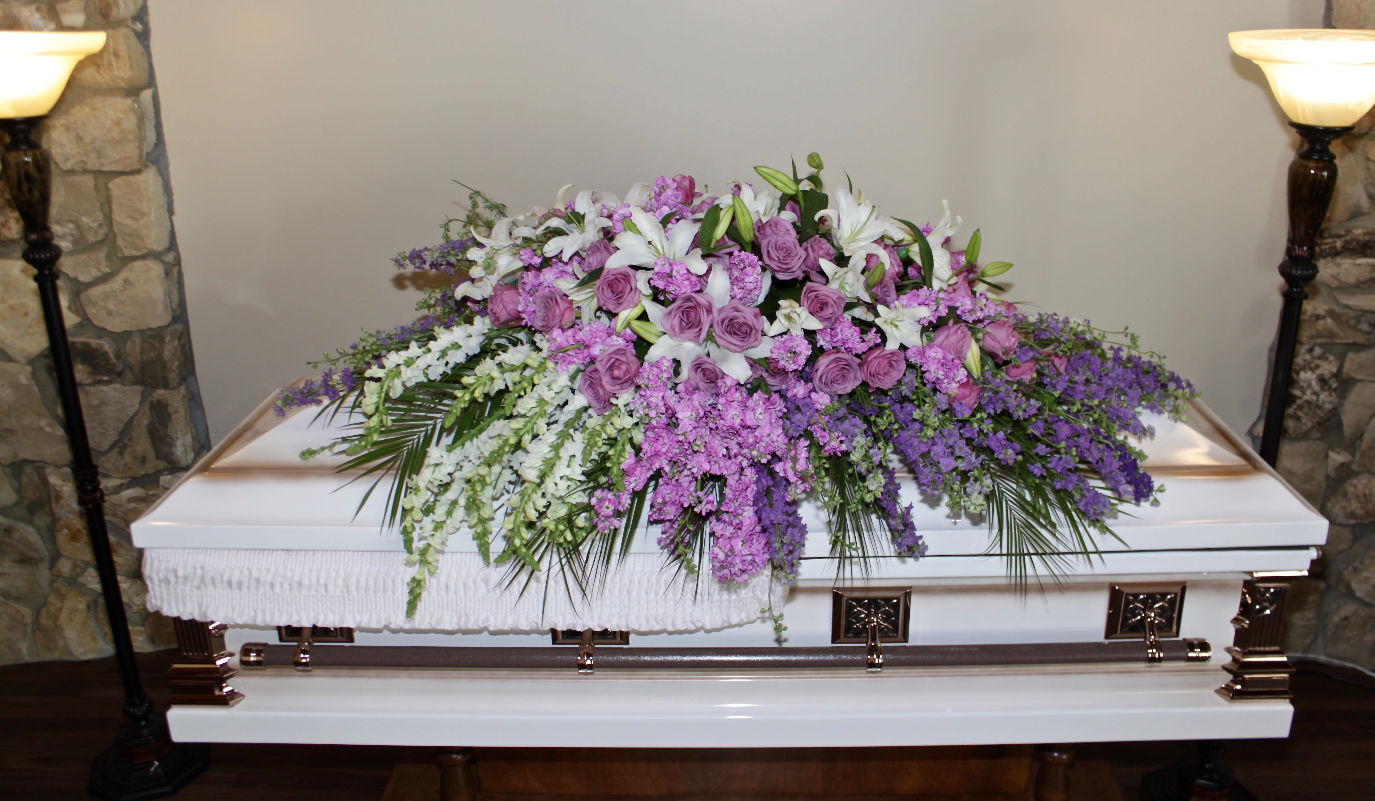 Lavender Rose Casket Lavender Rose Casket - This casket arrangement contains several different shades of lavender and purple florals. Standard size is half casket, deluxe is 3/4 and premium is full casket.