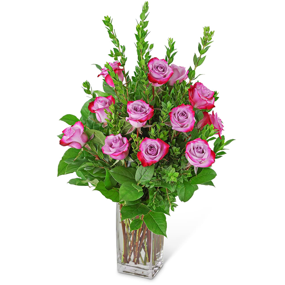 Vibrant Lavender Roses (12) Vibrant Lavender Roses (12) - While lavender roses signify love at first sight, they are also the perfect gift for anyone who loves purple! This bouquet contains 12 lavender roses mixed with a variety of fresh foliage in a tall rectangular vase. Vibrant Lavender Roses will make a beautiful anniversary or just because gift for that special someone.