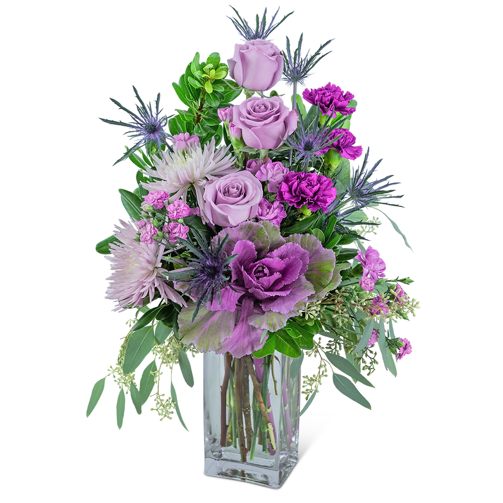 Wild Amethyst - This jewel of an arrangement will brighten anyone’s day! Wild Amethyst contains roses, spider mums, kale, carnations, dianthus, and a variety of foliage displayed in a tall clear vase. This stunning piece will make any home or office sparkle.