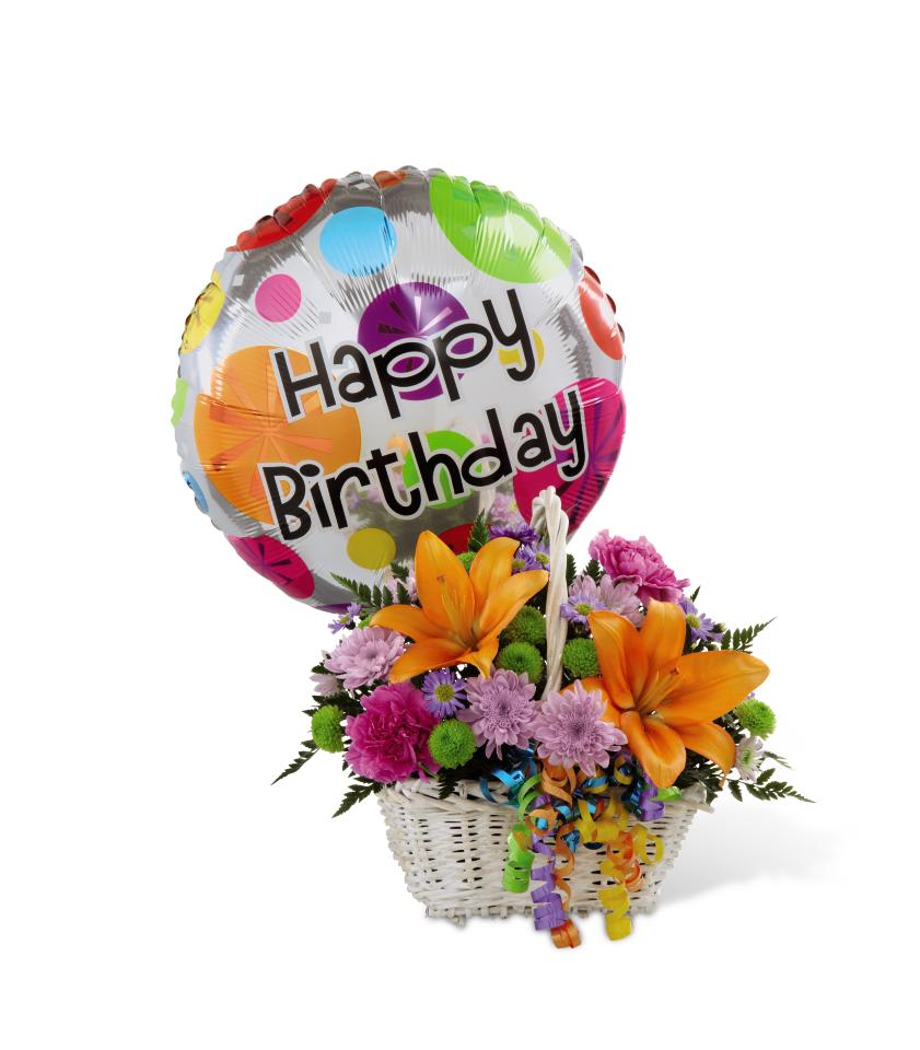 HAPPY BLOOMS BASKET - The FTD Happy Blooms Basket brings together Asiatic lilies and  carnations to create the perfect way to send your happy birthday wishes!  Orange Asiatic lilies, lavender chrysanthemums, lavender carnations,  purple monte casino asters, green button poms and lush greens are  beautifully arranged within a rectangular whitewash willow handled  basket accented with colorful curling ribbon. Arriving with a bright  Mylar balloon exclaiming, Happy Birthday, this flower arrangement will  add to the celebration of their special day. Approx. 11H x 12W.    