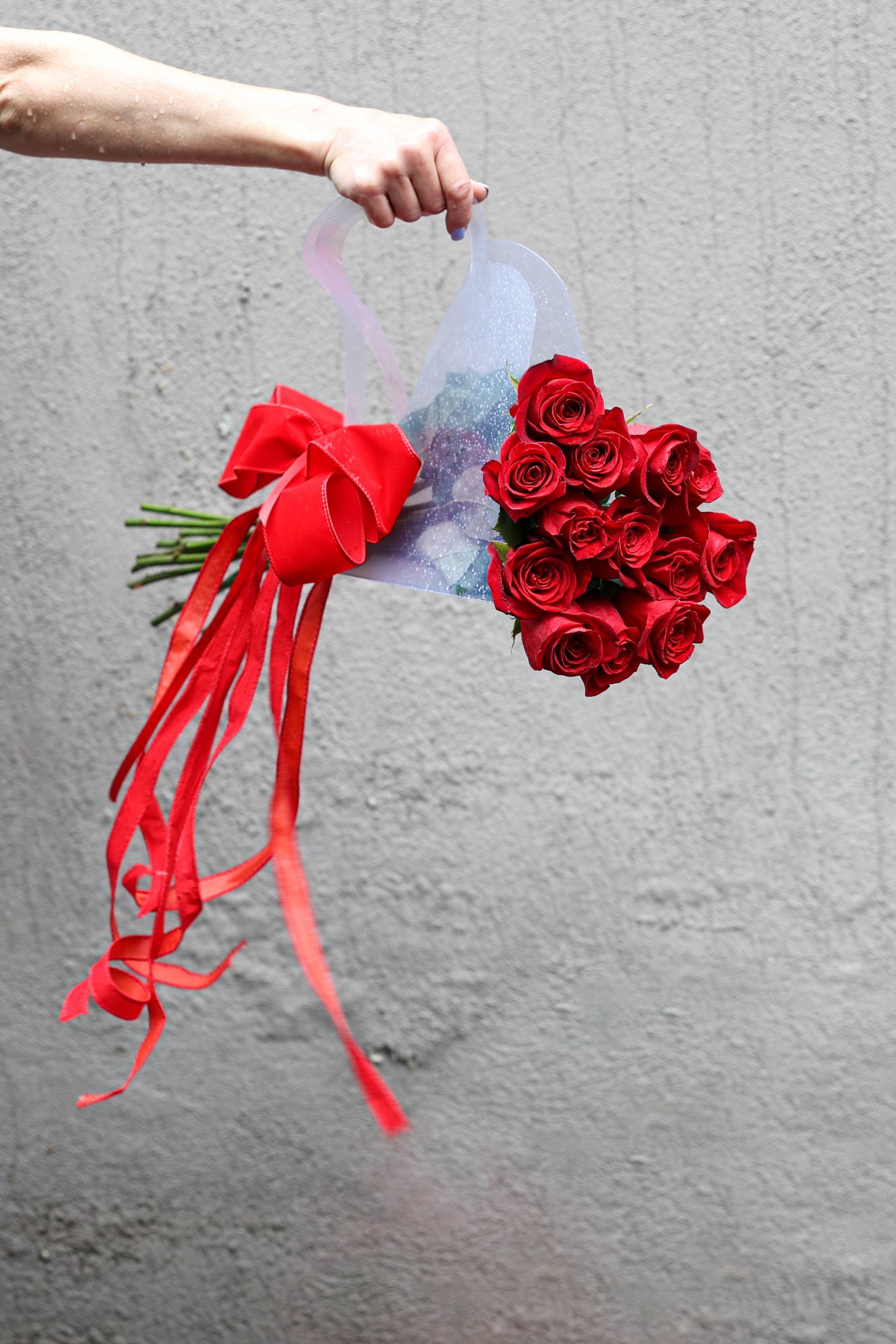 12 Red Roses in a plastic bag with a red bow - 12 Red Roses in a plastic bag with a red bow