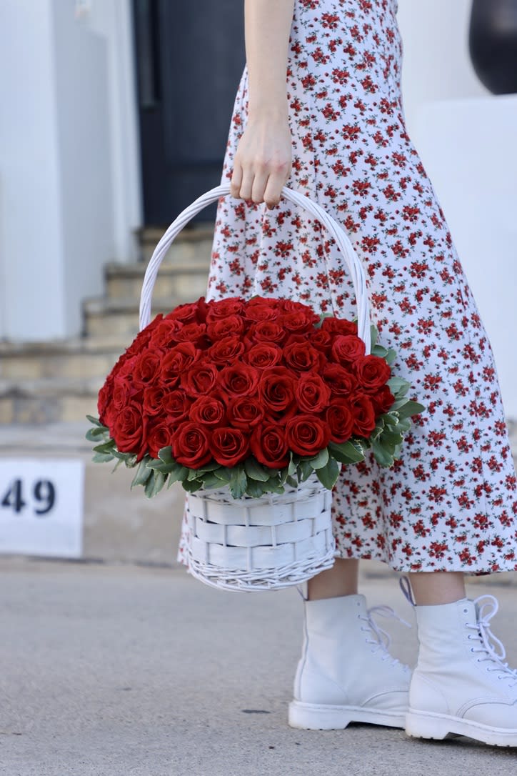 A Busket With Red Roses A Busket With Red Roses - A basket filled with red roses is a beautiful and classic way to present a bouquet of these beloved flowers. The basket is made from high-quality materials, such as wicker or wire, and is designed to hold the roses securely in place while also adding to the overall beauty of the arrangement. The red roses are carefully selected for their deep, rich color and velvety texture. They are arranged in a lush and abundant bouquet, creating a sense of romance and elegance. The stems may be left long and exposed, or they may be trimmed to fit the basket, creating a neat and organized appearance. The basket may be decorated with additional greenery or ribbon, adding to the overall beauty and charm of the arrangement. It can be easily carried and transported, making it a great gift for a range of occasions. The red roses in a basket are perfect for expressing love and admiration, making them a popular choice for Valentine's Day, anniversaries, and other romantic occasions. Their timeless beauty and classic charm make them a wonderful way to show someone special how much they are loved and appreciated. The basket can be reused and enjoyed long after the roses have faded, making it a lasting and meaningful gift.