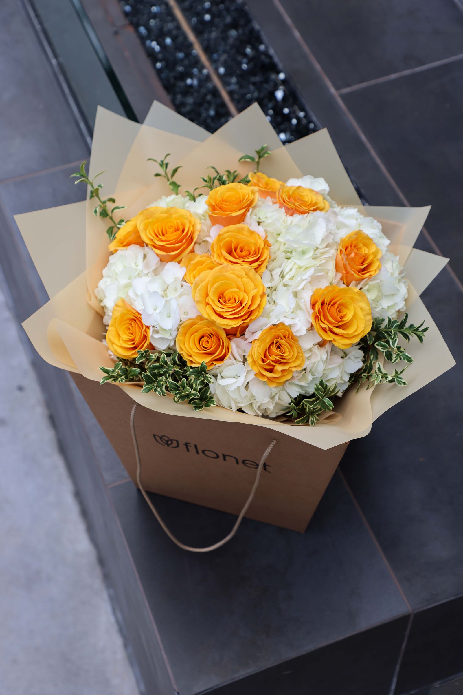 Citrus Blush Bouquet Citrus Blush Bouquet - A mix of Orange Color Roses and White Hydrangea in a Kraft Box
