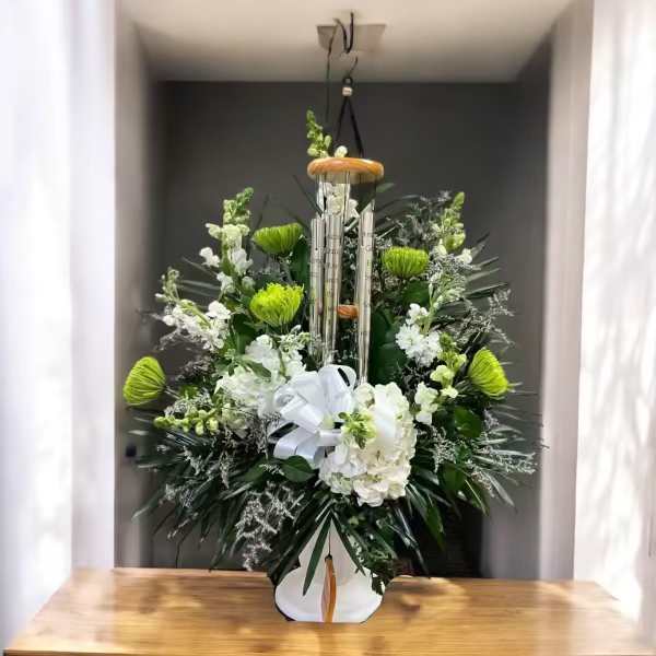 Quiet Moments Quiet Moments - This lovely gift of Quiet Moments will let you reflect of the passing of your loved one or friend. And the wind chime will always forever be a memory of them. Designed in a tall white urn with spider mums, hydrangeas, snap dragons, stock and other blooms