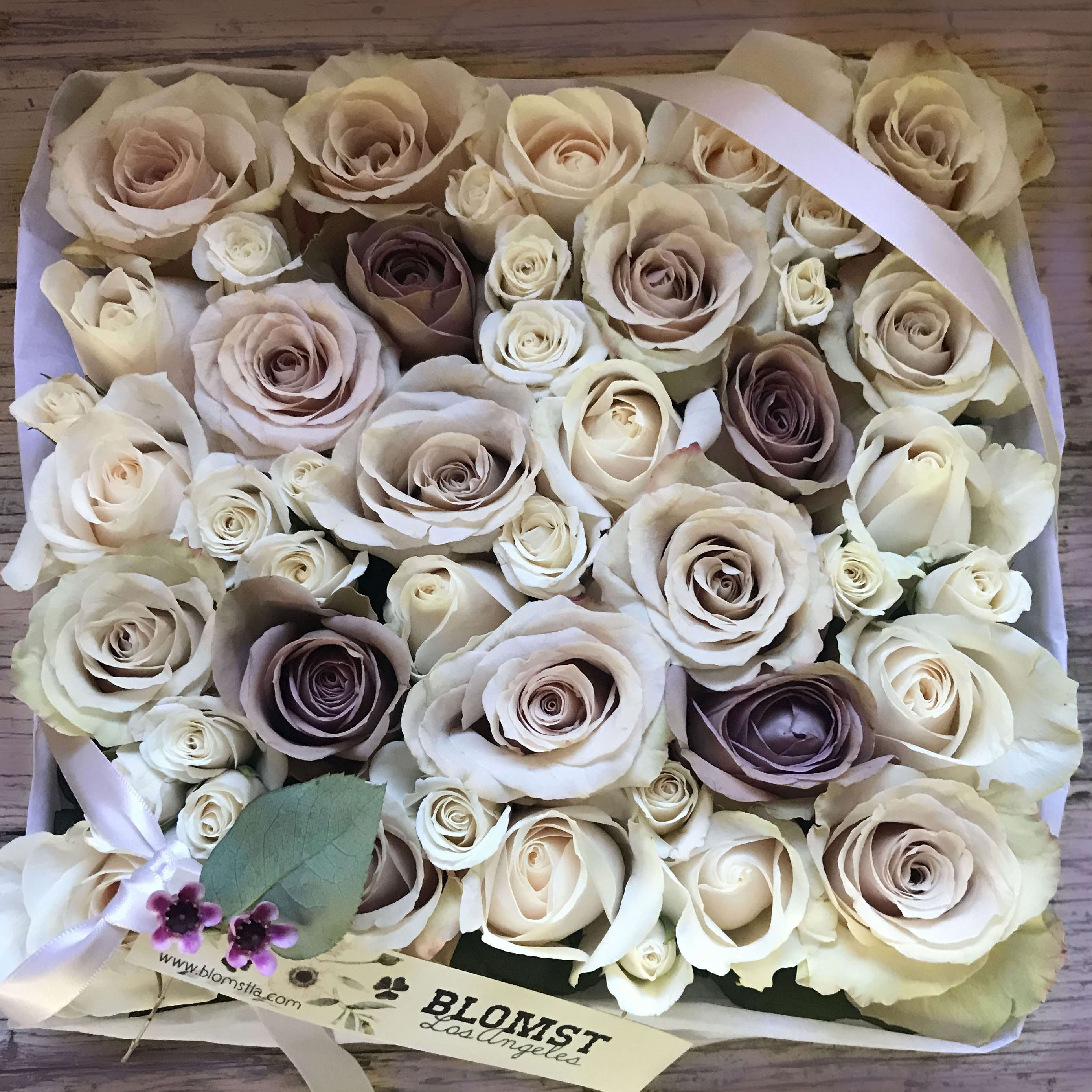 Prairie Rose Box - Perfect pale pastels in this gorgeous signature Blomst rose box. The wooden box is 8&quot; b 8&quot; and 4&quot; tall and contains minimum 25 beautiful roses of the highest quality. Wrapped in silk paper, beautiful ribbon and cute wrapping details. You can upgrade to Deluxe for more roses and to Premium for a larger box (14&quot; by 14&quot;) filled with more gorgeous roses.  Blomst LA only uses fresh, high quality flowers, all carefully selected every day to fit your flower order. We offer a personal hand delivery by our own delivery staff and guarantee the flowers will look perfect, when they arrive. We deliver in Glendale, Pasadena, Eagle Rock, Hollywood, Burbank, Beverly Hills - and everywhere else in Greater Los Angeles.
