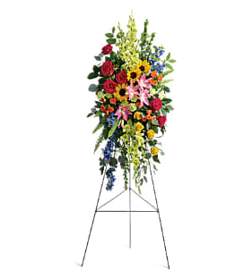 Love Lives On Spray Love Lives On Spray - Bursting with joy, this radiant spray of rainbow blooms is an exuberant tribute to never-ending love.