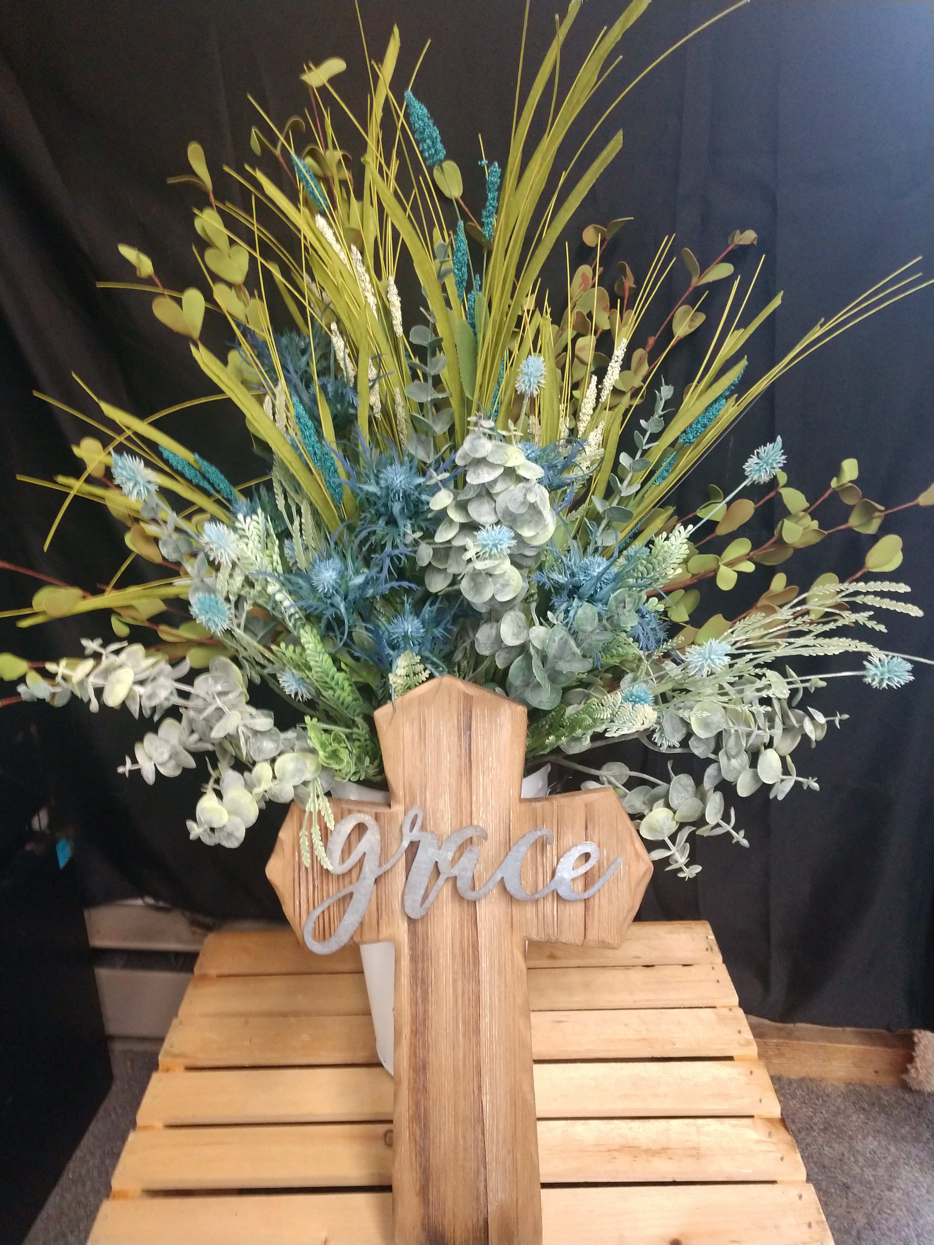 Grace (Silk Arrangement) - All silk flowers in a white galvanized bucket soak flowers are meadow grass blue thistle seeded eucalyptus regular eucalyptus 30 in high 18 in wide the cross is wood