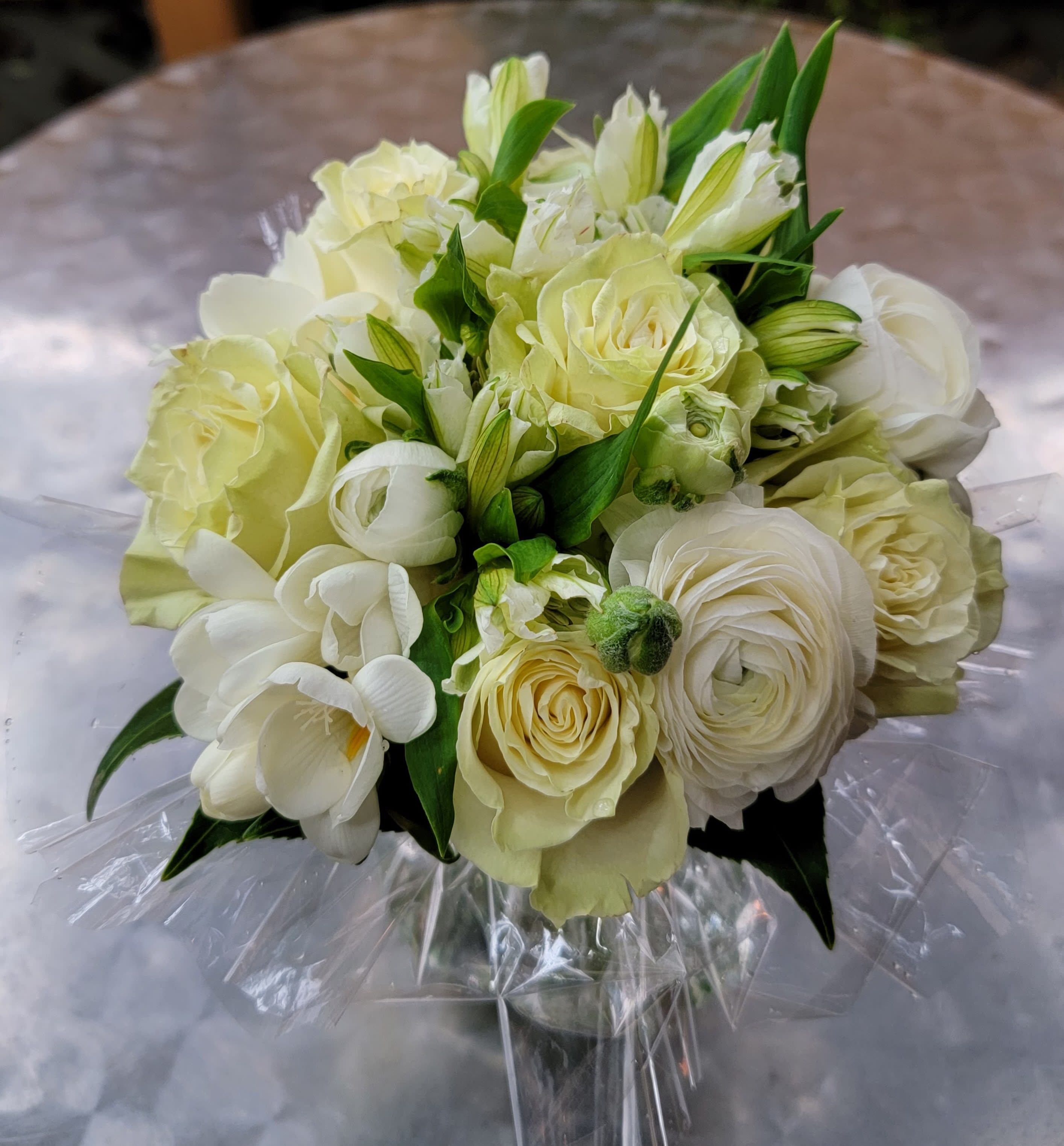 White Bouquet in a bag - Buddies Flowers original. The bag is a vase. White roses and white flowers of the season. Always an elegant/classic choice.