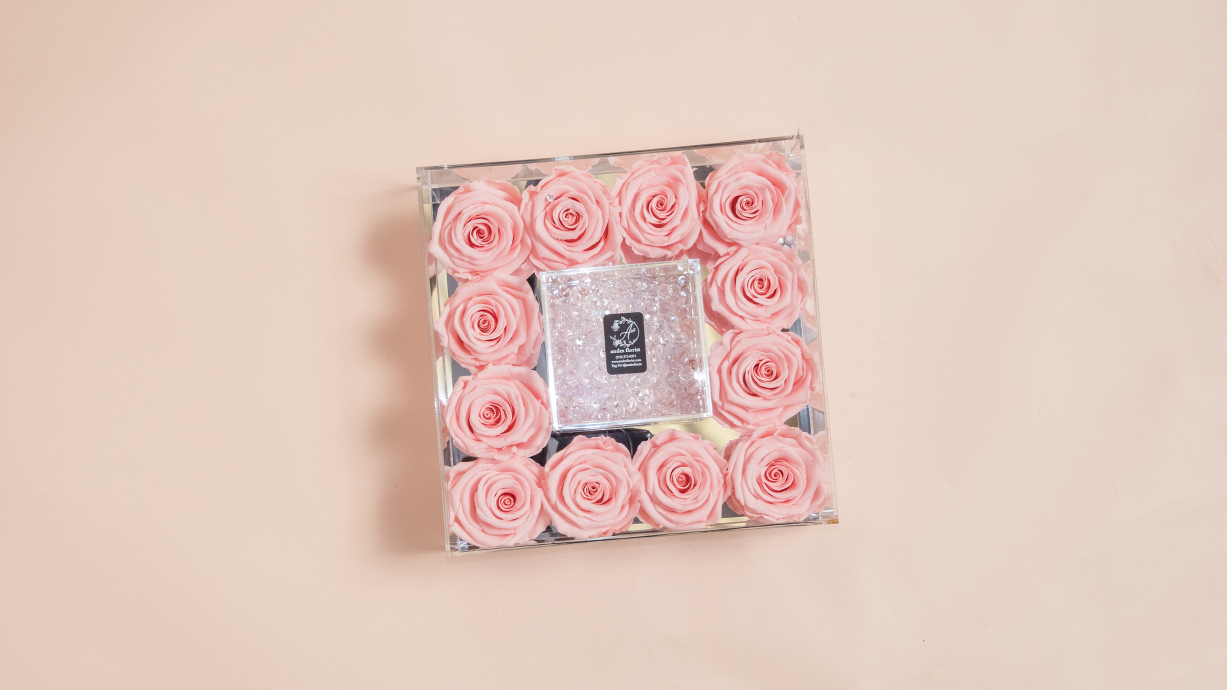 Dozen One Year Roses in a Mirrored Case - Blush Pink Dozen One Year Roses in a Mirrored Case - Blush Pink - A dozen Everlasting Roses, in a beautiful mirror bottomed case. In the center, you have an open space to place a special gift or a sweet greeting card (Complimentary greeting card included). These are REAL rose that can last for up to a year, or longer! About: Our Everlasting Roses are imported directly from Ecuador where they are treated with a proprietary solution and color pigmentation process that transforms them into long-lasting roses that maintain their freshness and biological structure. The roses are treated using a non-toxic and non-allergenic wax formula that is similar to silica. The outcome is that our roses continue to look and feel like real roses - because they are real - with the difference being that they will maintain their integrity and color for up to a year. Maintenance: The only maintenance they require is a light dusting from time to time. Do NOT water the roses. Do NOT remove the roses from their container. Do NOT place anything onto the roses as they can crush and damage them. Avoid direct exposure to sunlight. Keep the arrangement in a room temperature environment.