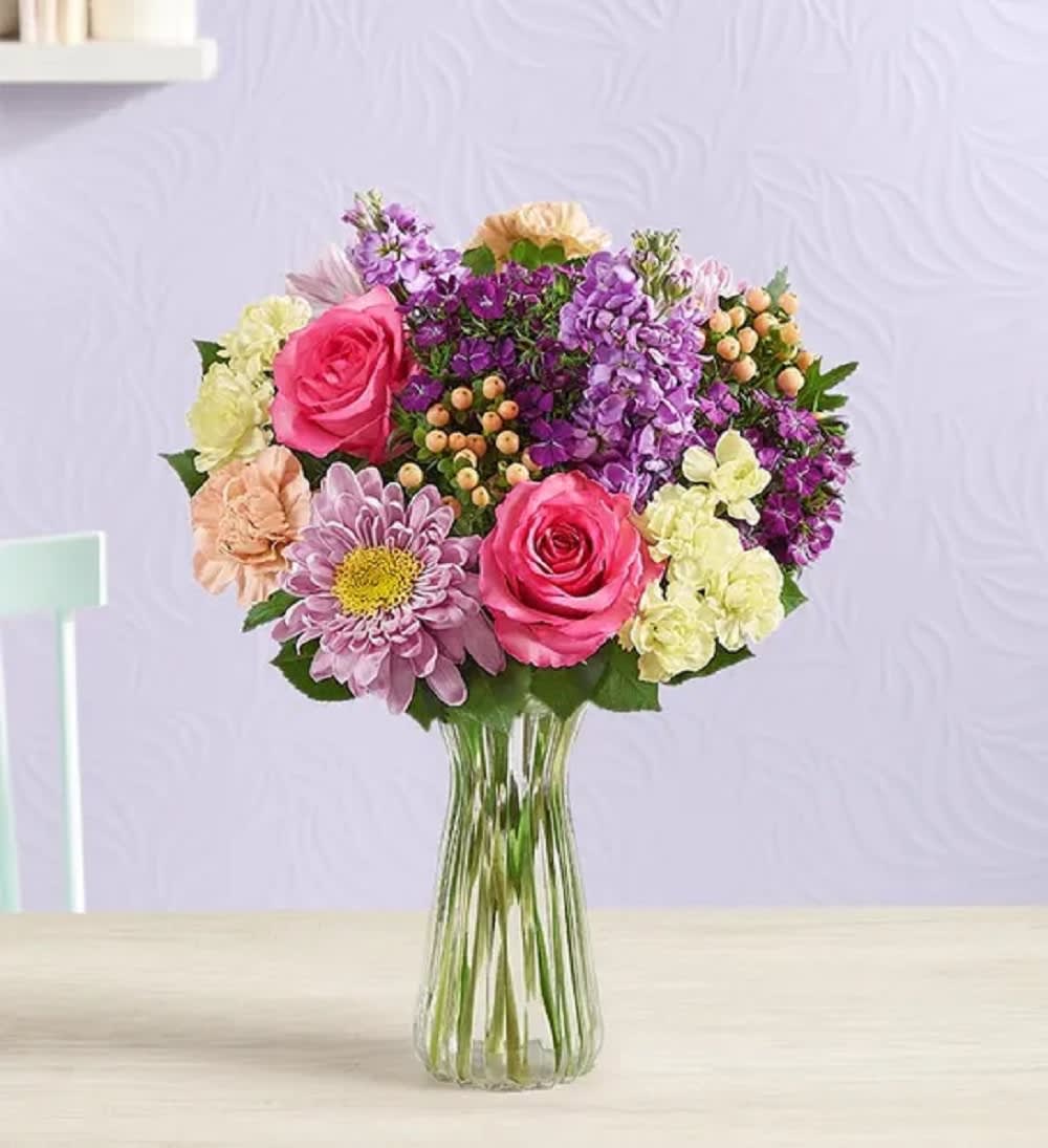 Precious Love Arrangement - Capture that sentiment with our lovely, English garden-inspired arrangement. It’s a simple yet stunning way to remind her how much she means to you… on Mother’s Day or any day of the year.  DETAILS Filled with a unique variety of blooms in pink, peach, yellow, and shades of purple.  VASE INCLUDED Orientation: One-Sided Item #NF-893  FLORIST-TO-DOOR Same day flower delivery on most orders placed online by 12 pm or 10 am on weekends PST.  BLOOM DETAILS Roses Mini Carnations Carnations Mums Stock Hypericum Seasonal Filler Greenery  The Standard Arrangement - (clear vase) The Deluxe Arrangement - (purple vase) The Premium Arrangement - (clear vase with more flowers)  How to place an order? 1. You can place an order directly on this secure website OR 2. You can call in your order by dialing: (323) 262 - 9238 OR 3. You can visit our store (appointment recommended 323.262.9238)  NINFA'S FLOWERS 2405 WHITTIER BLVD. LOS ANGELES, CA. 90023  ATTENTION: *Please note that on busy holidays, Valentine's Day, and Mother's Day, we cannot verify if the recipient received the flowers until the following day. You can verify delivery on the website after 10:00 pm, call 323.262.9238 the following day after 10:00 am, or contact the recipient directly. Thank you for your patience and understanding.