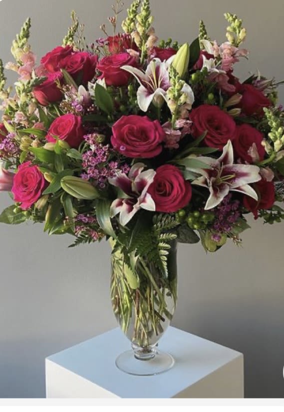 Garden of Love  - Stargazer Lillie’s, Roses, Wax Flower , green hypericum berries , pink snap dragons 