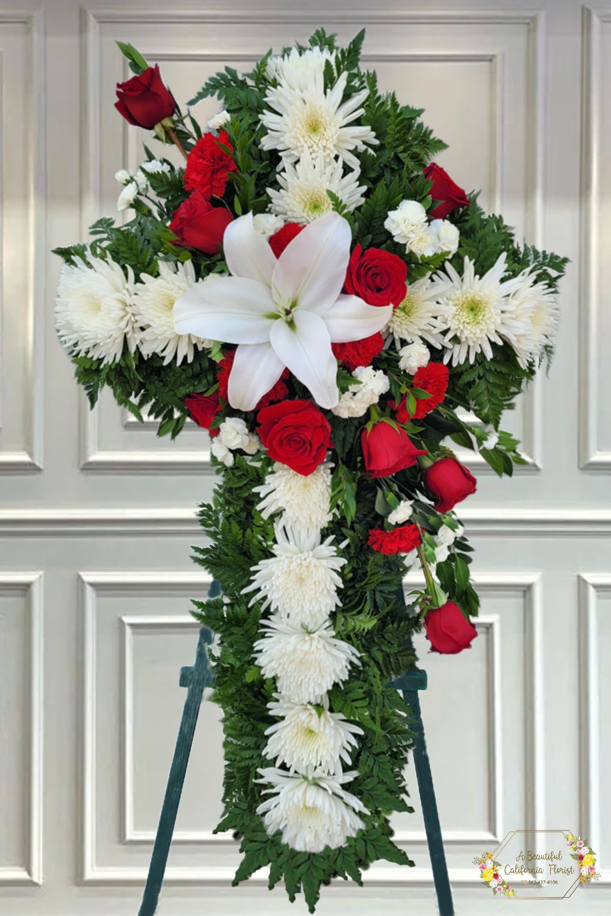 Red and White Cross on Easel 30 inch Red and White Cross on Easel 30 inch - Standard is 30 inch Cross on Easel With Beautiful RED Roses, White Lily and White Mums, accented by lush greens. Displayed on a wooden easel. A beautiful tribute.