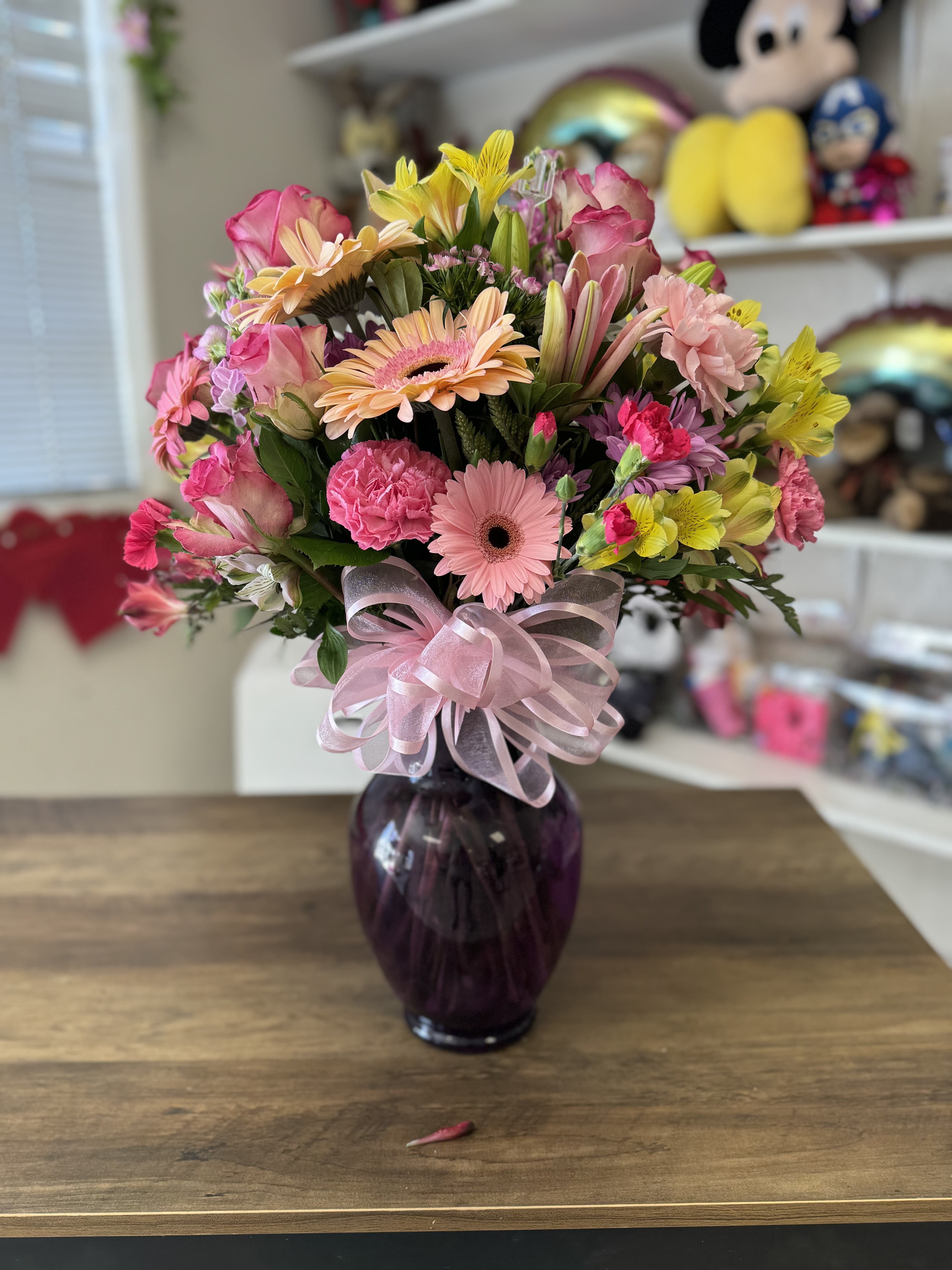 With in my Heart - A beau combination of light colored florals arranged in a tall colored vase 