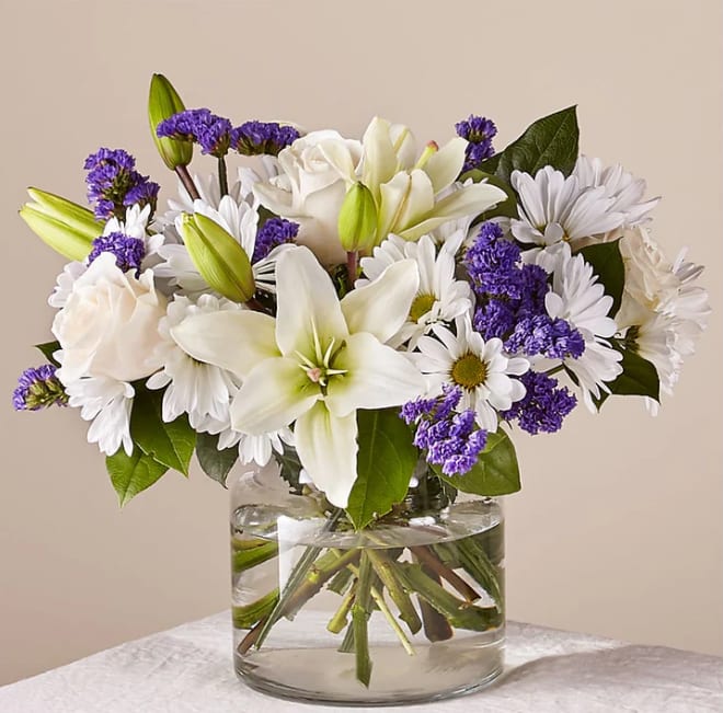 Beyond Blue Bouquet - There is something about the shade of blue that brings a sense of calmness and serenity. Our Beyond Blue bouquet is designed with billowing white blooms and pops of bold florals to deliver just the right sentiment for any reason.  Please Note: The bouquet pictured reflects our original design for this product. While we always try to follow the color palette, we may replace stems to deliver the freshest bouquet possible, and we may sometimes need to use a different vase.