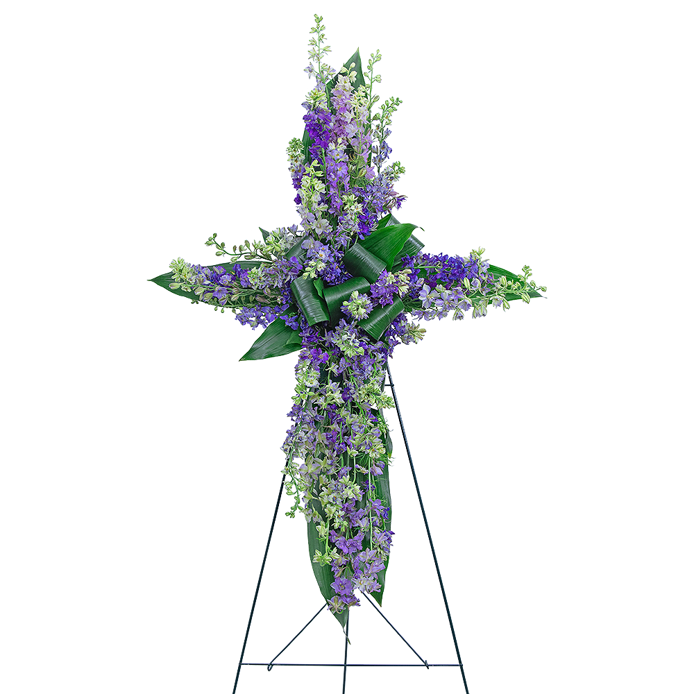 Larkspur Affinity Cross - Our Larkspur Affinity Cross standing spray is the perfect symbol of a loved one’s faith-filled life on earth. A variety of textures in premium foliage combine with lavender Larkspur to make a stunning and organic cross, made to be displayed near the casket or urn. Lavender flowers are commonly used in sympathy designs because they offer peace and tranquility. Sympathy flowers are the perfect way to honor a life or send your condolences to the grieving family.