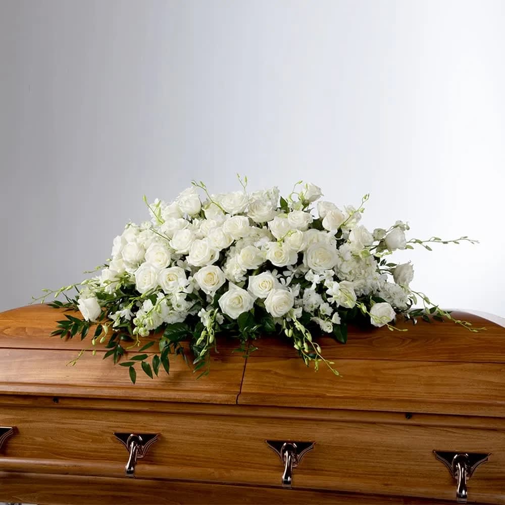 Tranquility Casket Spray by BloomNation™  - An all-white tribute, this full casket spray is pure and tranquil. This elegant spray evokes a feeling of peace.   DETAILS Featuring a variety of white flowers and greenery.  Orientation: One-Sided *If you would like to add a ribbon with a sentiment for an additional $10 each. Item #NF-1036  FLORIST-TO-DOOR Same day flower delivery on most orders placed online by 12 pm or 10 am on weekends PST.  BLOOM DETAILS Roses Dendrobium Orchids Delphinium Hydrangea Greenery  The Standard Arrangement (SHOWN) The Deluxe Arrangement   The Premium Arrangement  INSTRUCTIONS: 1.) Please have the business name of the funeral home, address &amp; phone number. 2.) Please have the first name &amp; last name of the deceased. 3.) Please have the start time of the services. 4.) If you would like for us to write a brief message on a small business card-size note, please have your message ready.  How to place an order? 1. You can place an order directly on this secure website OR 2. You can call in your order by dialing: (323) 262 - 9238 OR 3. You can visit our store (appointment recommended 323.262.9238)  NINFA'S FLOWERS 2405 WHITTIER BLVD. LOS ANGELES, CA. 90023  ATTENTION: *Please note that on busy holidays, Valentine's Day, and Mother's Day, we cannot verify if the recipient received the flowers until the following day. You can verify delivery on the website after 10:00 pm, call 323.262.9238 the following day after 10:00 am, or contact the recipient directly. Thank you for your patience and understanding.
