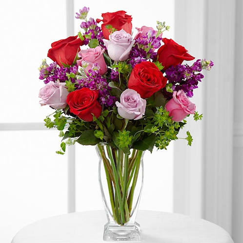 The FTD Garden Walk Bouquet - The FTD Garden Walk Bouquet is an exquisite expression of natural beauty and grace. Assorted lavender roses, rich red roses, purple stock and lush greens have a fresh look of floral elegance presented in a modern clear glass vase to create a sweet sentiment ideal to celebrate any of life's special moments. GOOD bouquet includes 12 stems. Approx. 15âH x 11âW. BETTER bouquet includes 16 stems. Approx. 17âH x 13âW. BEST bouquet includes 21 stems. Approx. 20âH x 16âW.