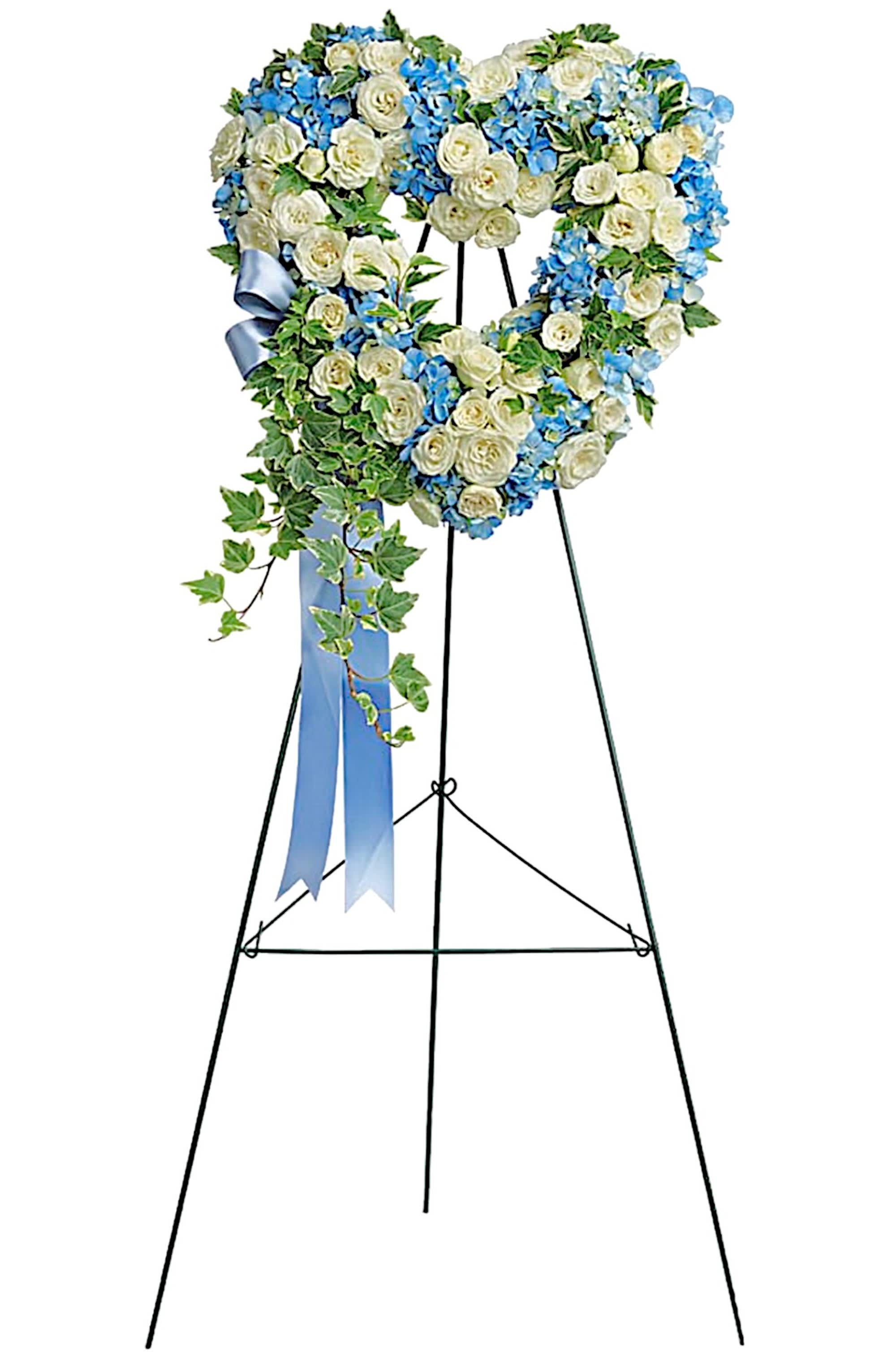 Pure Heart - Petite  - Adorned with trailing ivy, this petite, 16&quot; sweetheart-shaped wreath of sky-blue hydrangea and pure white roses is a loving remembrance. Arrives on an easel. Appropriate for the funeral home, memorial service, or gravesite.  DETAILS This heartfelt arrangement features blue hydrangea, white spray roses, and variegated ivy. Open, heart-shaped arrangement is delivered on a wire easel.  EASEL INCLUDED Orientation: One-Sided *If you would like to add a ribbon with a sentiment for an additional $10 each. Item #NF-1060  FLORIST-TO-DOOR Same day flower delivery on most orders placed online by 12 pm or 10 am on weekends PST.  BLOOM DETAILS Spray Roses Hydrangeas Greenery  The Standard Arrangement is approx. 26&quot; H x 16&quot; W without easel. (SHOWN) The Deluxe Arrangement is approx. 28&quot;H x 18&quot;W without an easel. The Premium Arrangement is approx. 30&quot;H x 20&quot;W without an easel.  How to place an order? 1. You can place an order directly on this secure website OR 2. You can call in your order by dialing: (323) 262 - 9238 OR 3. You can visit our store (appointment recommended 323.262.9238)  NINFA'S FLOWERS 2405 WHITTIER BLVD. LOS ANGELES, CA. 90023  ATTENTION: *Please note that on busy holidays, Valentine's Day, and Mother's Day, we cannot verify if the recipient received the flowers until the following day. You can verify delivery on the website after 10:00 pm, call 323.262.9238 the following day after 10:00 am, or contact the recipient directly. Thank you for your patience and understanding.