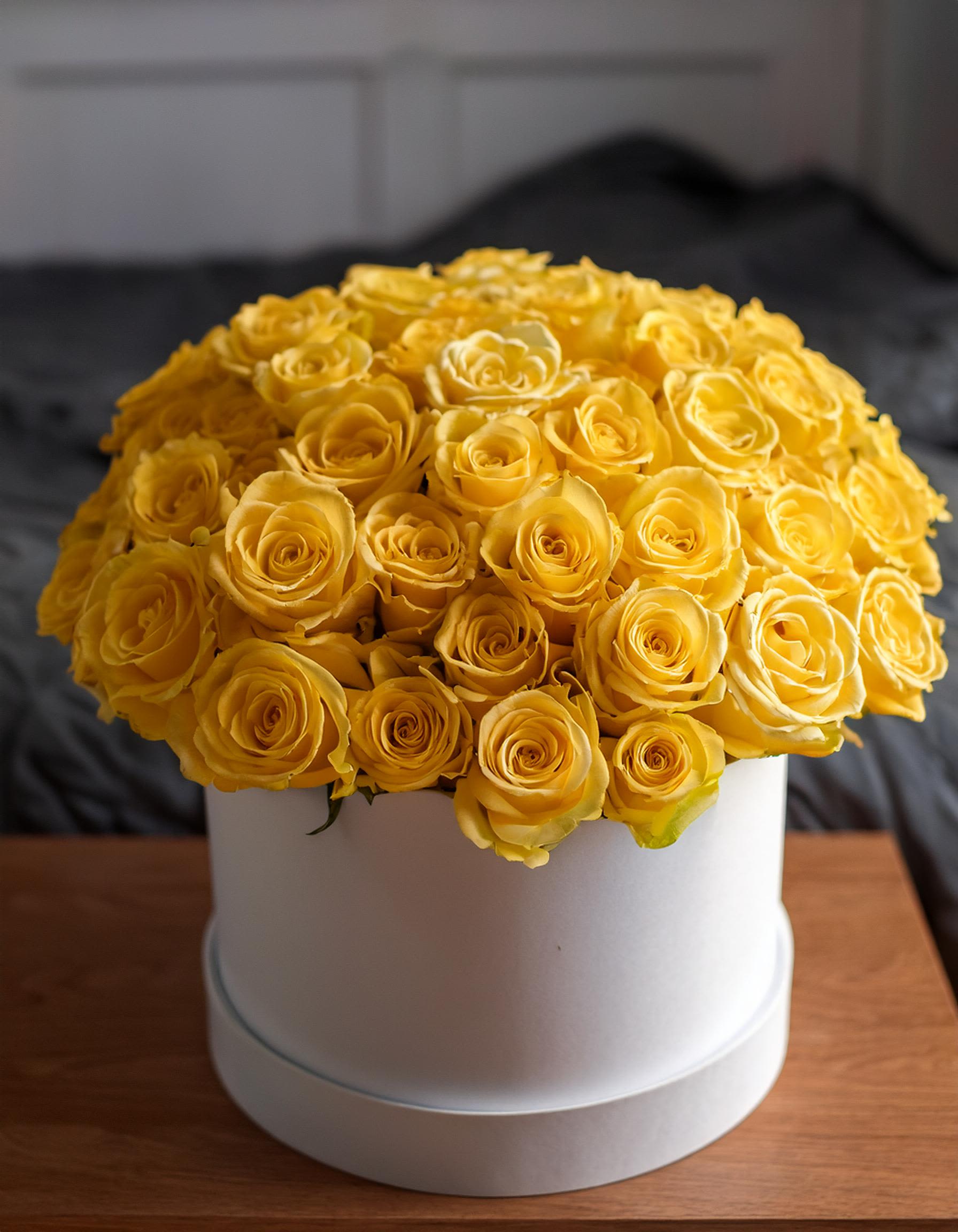 Murmurs of Affection Murmurs of Affection - Indulge in the luxury with our exquisite bright yellow roses, beautifully arranged in an elegant hatbox. Perfect for any occasion, this stunning display elevates your expression of love into something truly special. Disclaimer: IMAGES PROVIDED ARE ALL 75 ROSES