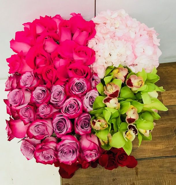 Eternal Bliss - Inside a square box, this glorious arrangement consists of lavender and hot pink roses, pink hydrengia and green cymbidiums.  It is truly grand and jaw dropping. 