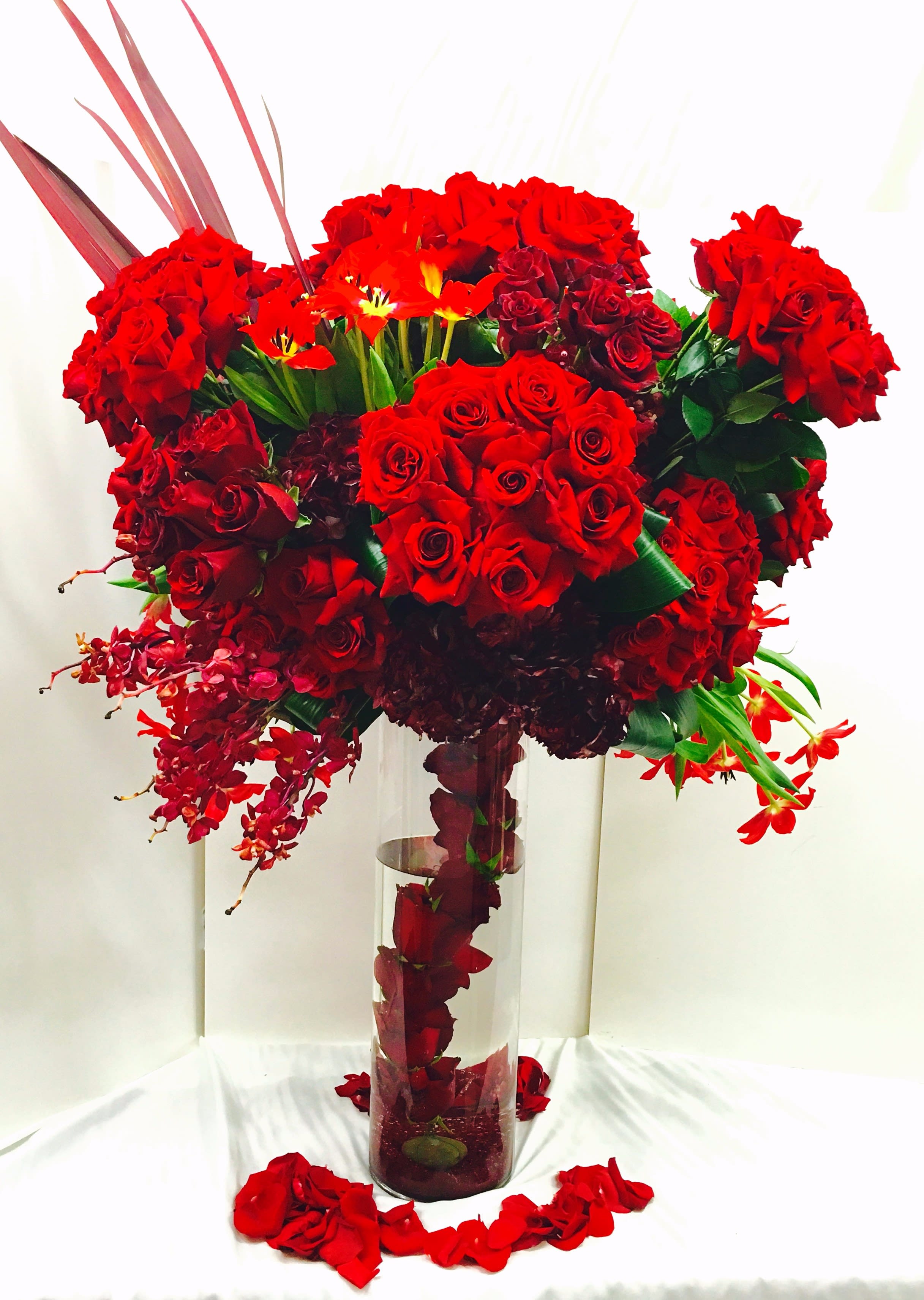 The Lady in Red Roses - This arrangement is truly a statement of love, with the bold and bright red. It speaks sophistication and elegance, perfect for celebrating Valentine's Day, your anniversary or even just to say how much you love someone.  *Standard size is approximately 45&quot; tall.