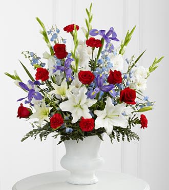Gratitude Arrangement - A dramatic floral salute respectfully features a heroic color palette of red, white and blue to honor the life of a hero. Our Gratitude Arrangement is designed with lilies, irises, delphinium and roses to share your sympathies with reverence and respect. While the lilies may initially arrive in bud form, they beautifully transform as they open. -  Bouquet Arrangement is approximately 36&quot;H x 30&quot;W