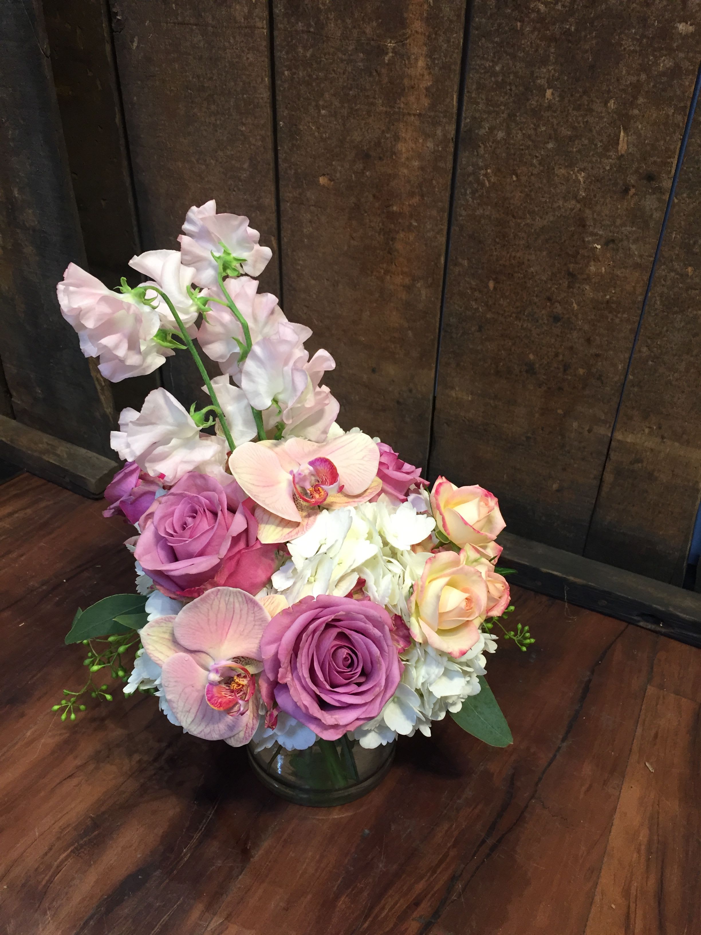 Mauve - A petit collection of pink sweet peas, hydrangea, roses, and phalaenopsis orchids. 
