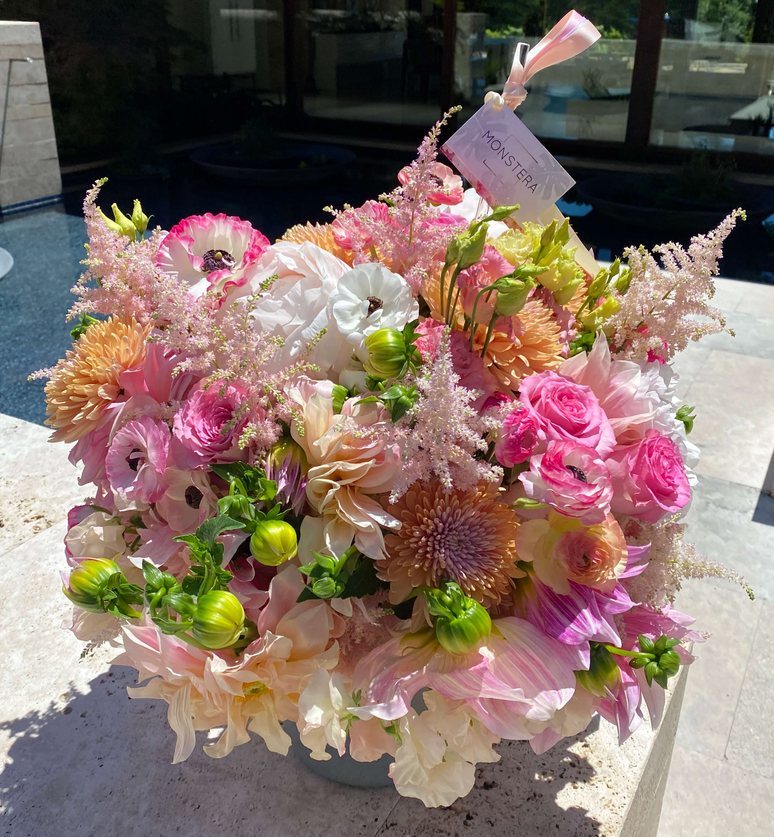 Pink Soiree - A large arrangement with an assorment of peonies, roses, dahlias, lisianthus, astilbe, mums, ranunculus, and other flowers. 