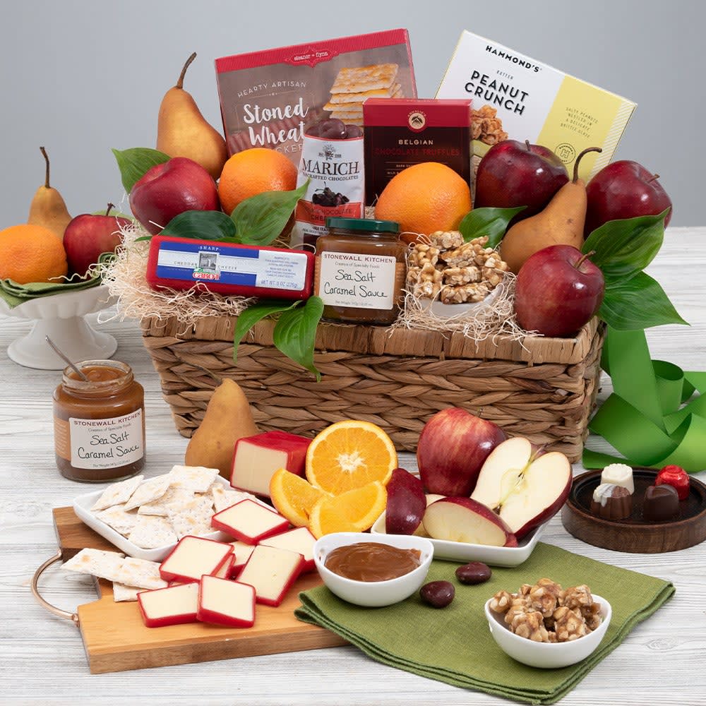 Orchard's Abundance - Fruit Gift Basket - With something for everyone, it's no surprise that this delightful gift is one of our most popular! Inside a water hyacinth gift basket, we've artfully arranged juicy oranges, crisp apples, and sweet pears, along with an assortment of delicious gourmet foods. Complete with Vermont cheddar cheese, chocolate-covered cherries, butter peanut crunch, Belgian chocolates, stoned wheat crackers, and a salted caramel sauce. This classic arrangement is perfect for any occasion.