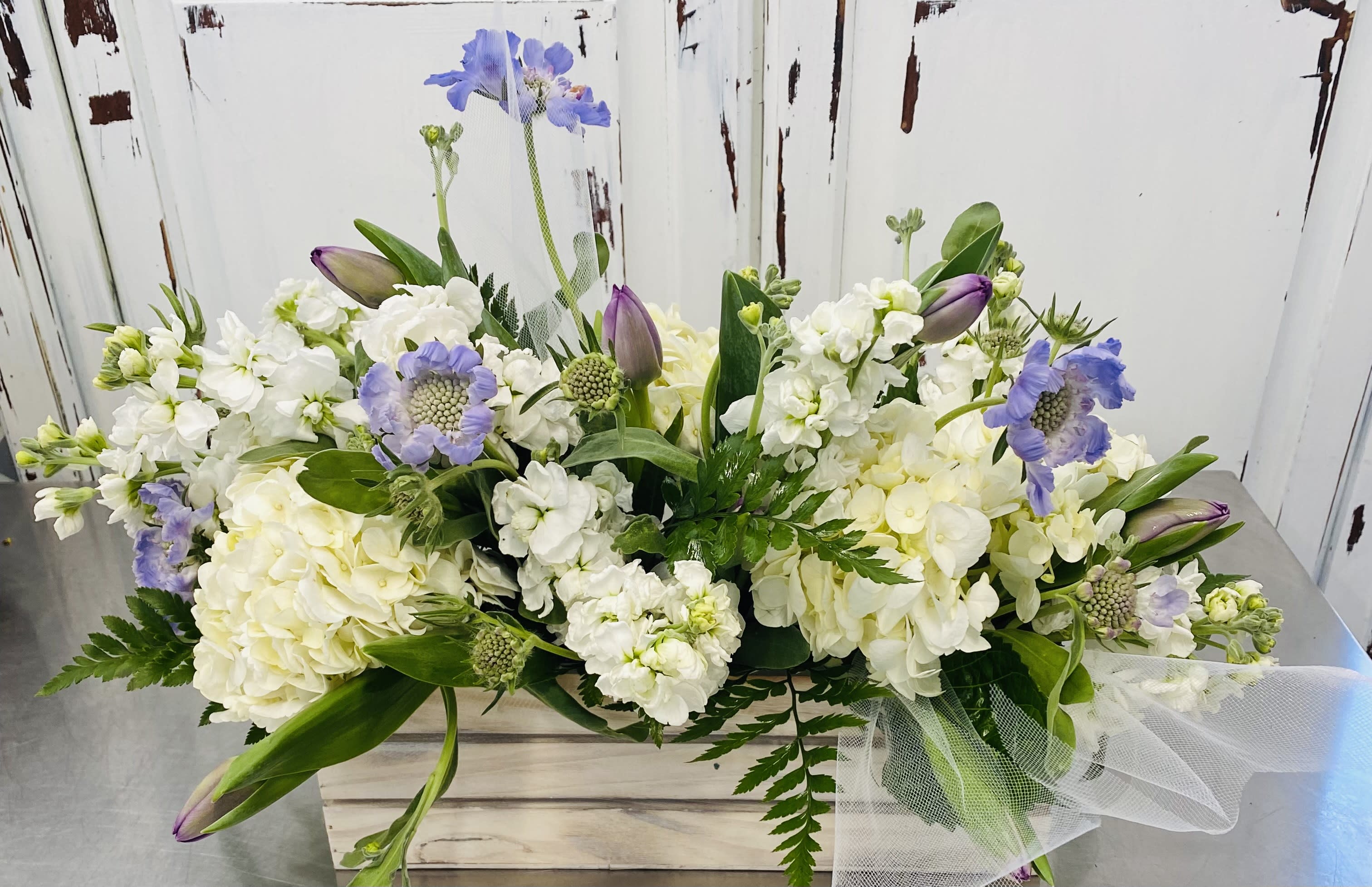 Soft with Sympathy - Subtle, Soft and comforting, this design is perfect to say how much you care and love its receiver. Soft, White and lavender. (Pictured) Hydrangea, stock, scabiosa &amp; tulips. Florist reserves the right to use what is seasonally available at the market, but will always keep it soft.