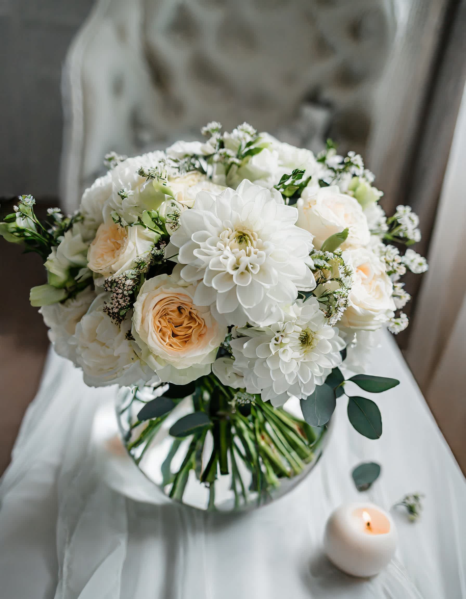 Moonlit Allure - A charming and beautiful bouquet featuring ivory roses, white dahlias, and an assortment of mixed flowers, elegantly presented in a clear vase.  Disclaimer: ALL IMAGES PROVIDED AT DELUXE PRICE Photos and visual presentation of the products represent an overall style, look and feel, which we may not be able to identically replicate in some instances  Recommended for: Love and Romance, I Love You Flowers, Anniversary, Proposal,  Romantic Gift, Birthday, Get Well Soon, Celebrations, Best Wishes, Thank You, Congratulations, Just Because, New Baby, Everyday, Sympathy