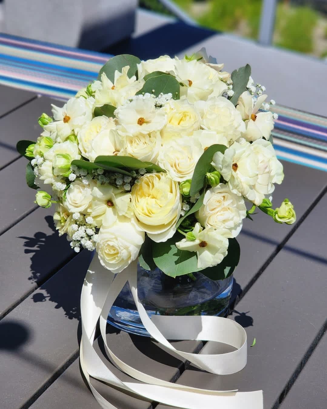A Light Breeze - In a vase, white roses and ranunculus create a stunning display. Eucalyptus leaves offer a green contrast, making a beautiful and fragrant  Recommended for: Love and Romance, I Love You Flowers, Anniversary, Proposal, Romantic Gift, Birthday, Get Well Soon, Celebrations, Best Wishes, Thank You, Congratulations, Just Because, New Baby, Everyday, Sympathy, Mother's Day Flowers  